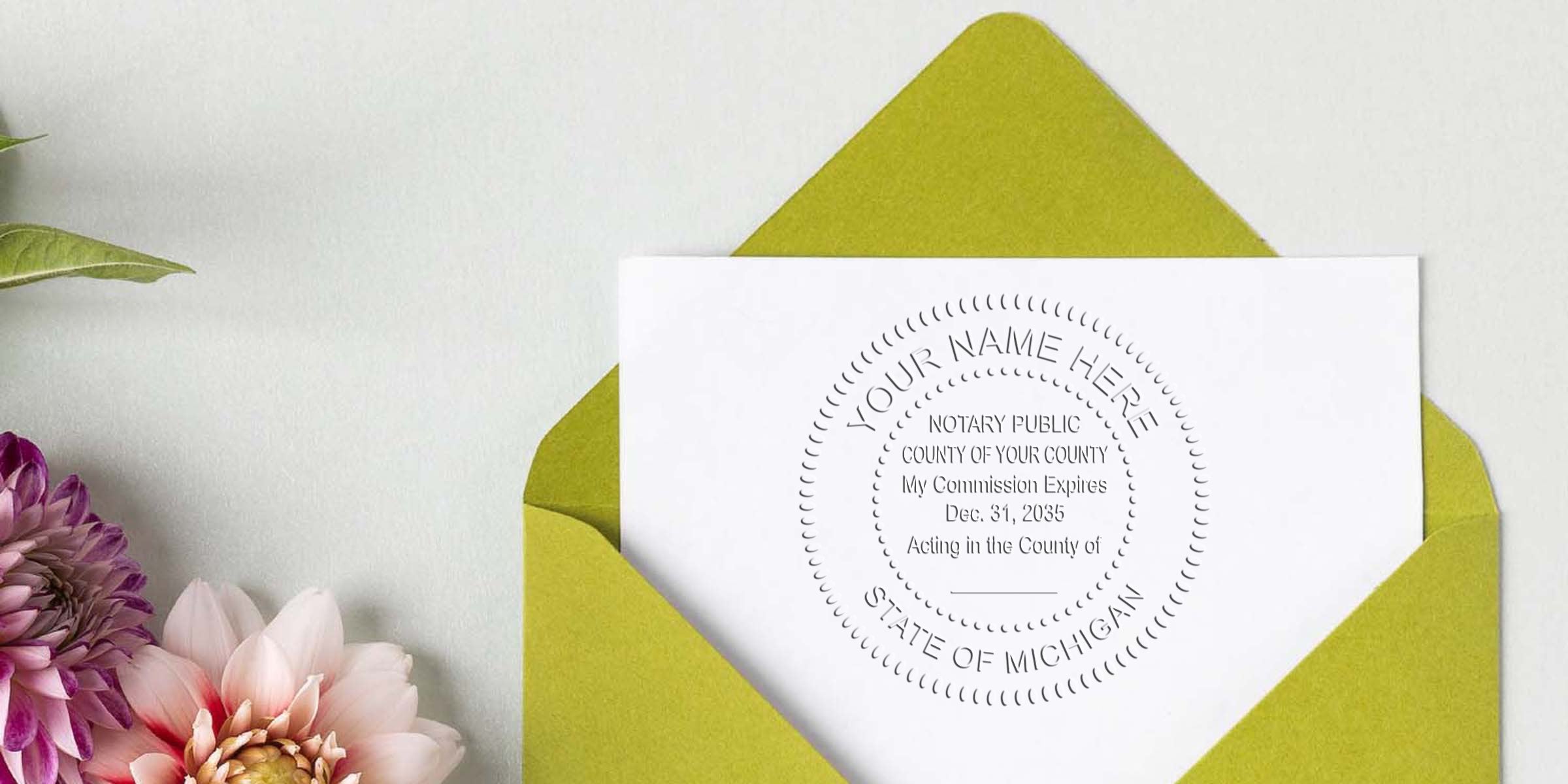 Notary seal stationery mockup: white card with embossed circular notary seal tucked in a lime-green envelope, flatlay with pink and purple dahlias on a light textured background — ideal for notary, legal stationery or invitation branding.