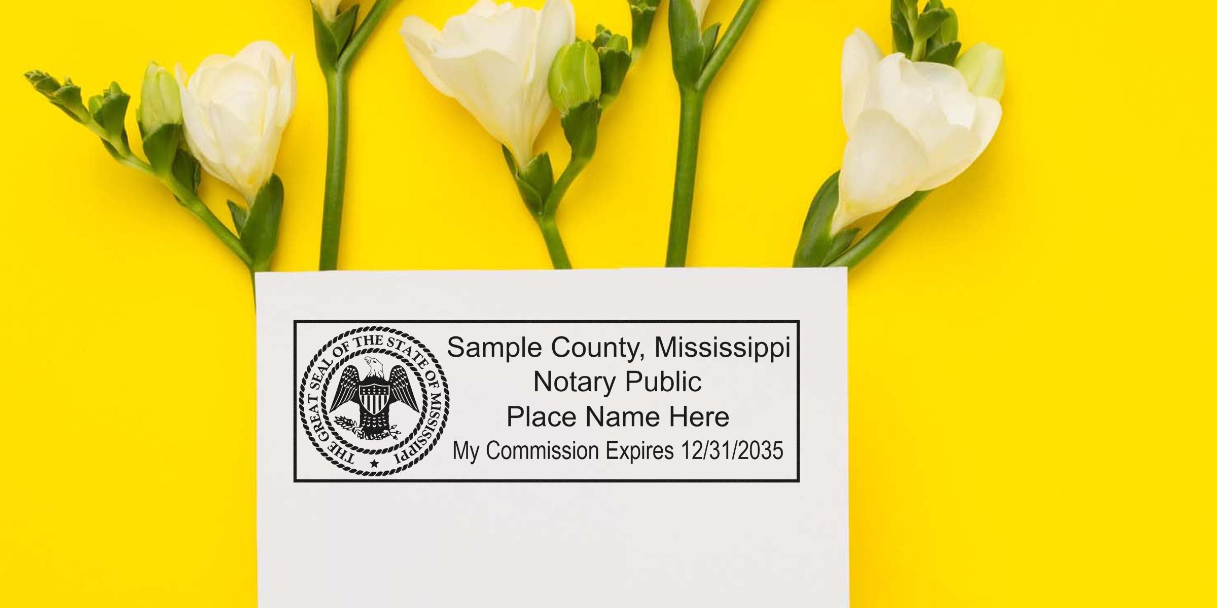 White envelope with Mississippi notary public stamp and commission expiration text, placed with white freesia flowers on bright yellow background — notary stamp on envelope.