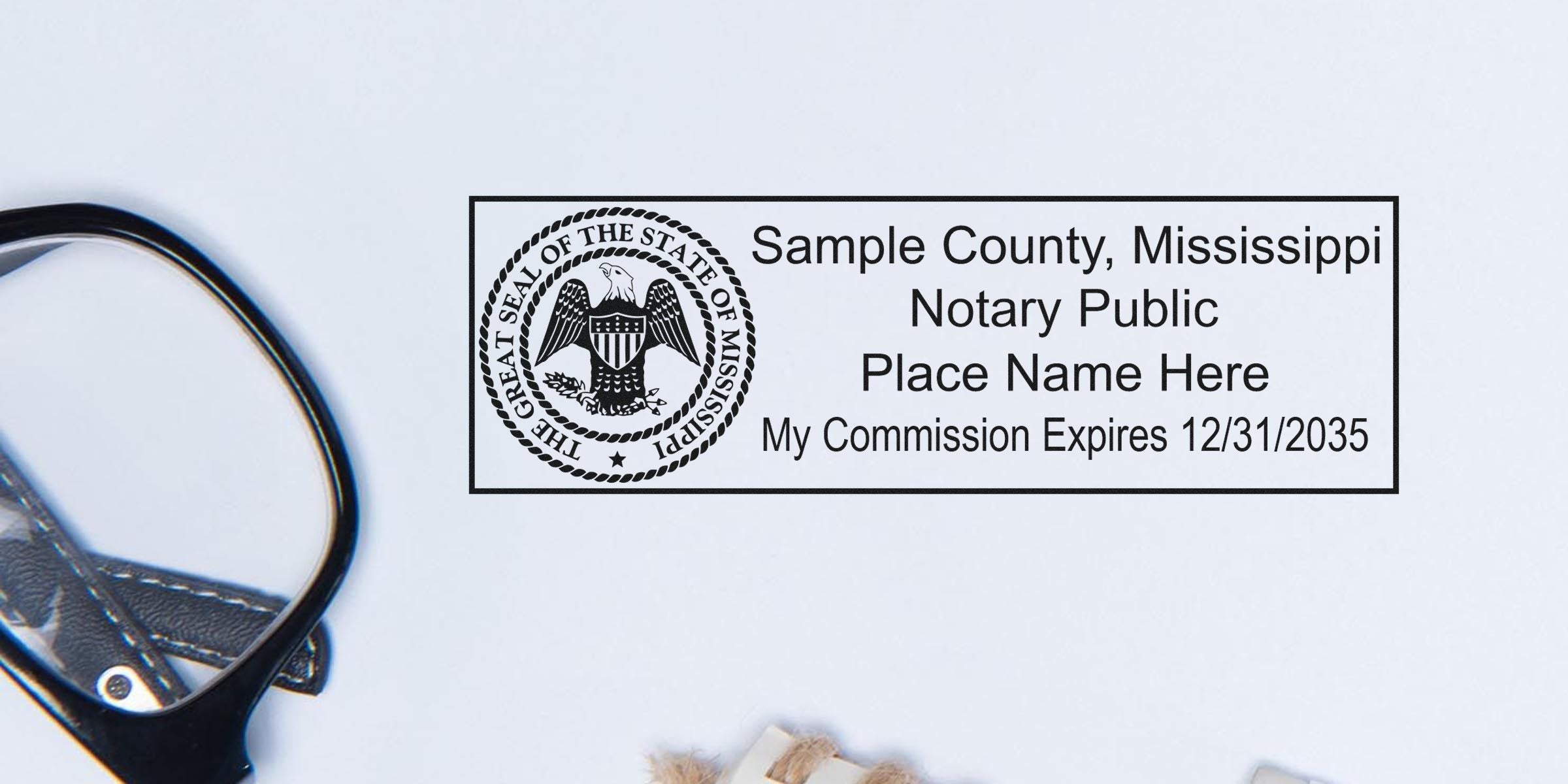 Rectangular notary public stamp with Mississippi state seal reading "Sample County, Mississippi Notary Public," placeholder name and "My Commission Expires 12/31/2035" on white background, magnifying glass partially visible.