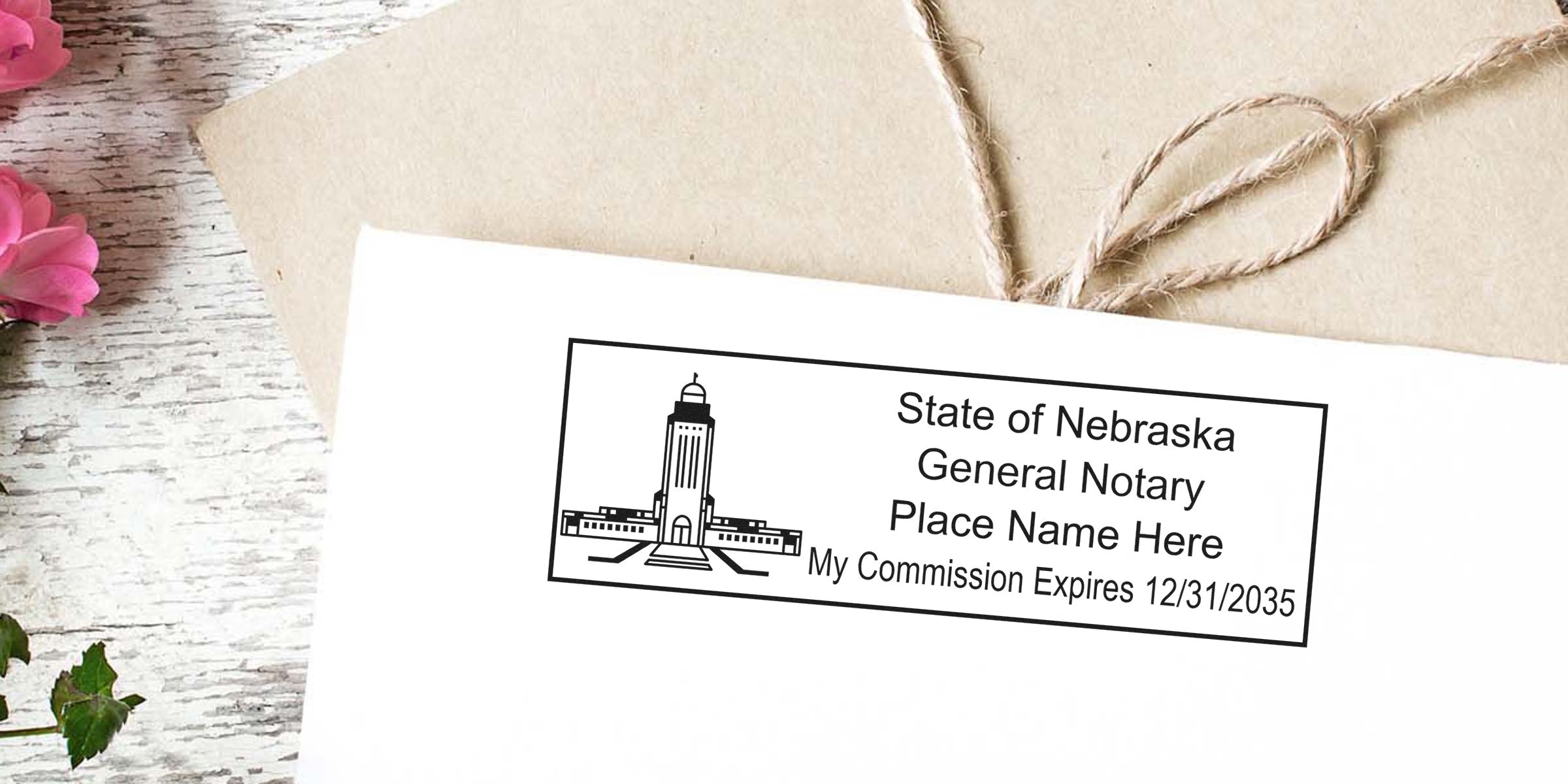 Envelope with State of Nebraska general notary stamp impression showing placeholder name and commission expiration date, kraft envelope tied with twine, pink flowers and rustic white wood background — Nebraska notary stamp on mail