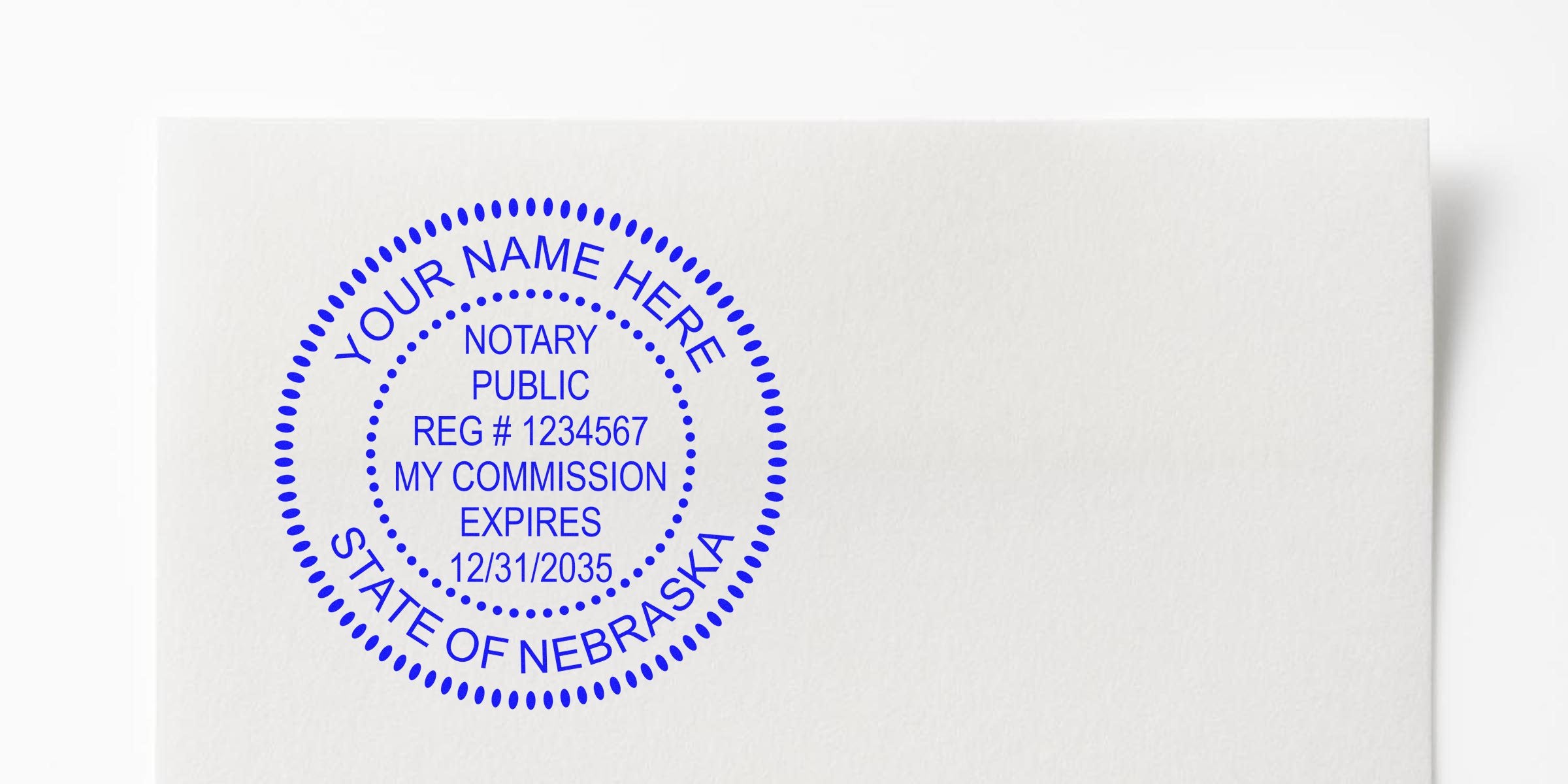 Blue circular notary public stamp on white paper reading "Your Name Here," "Notary Public," registration number and commission expiration date, with "State of Nebraska" in outer ring.