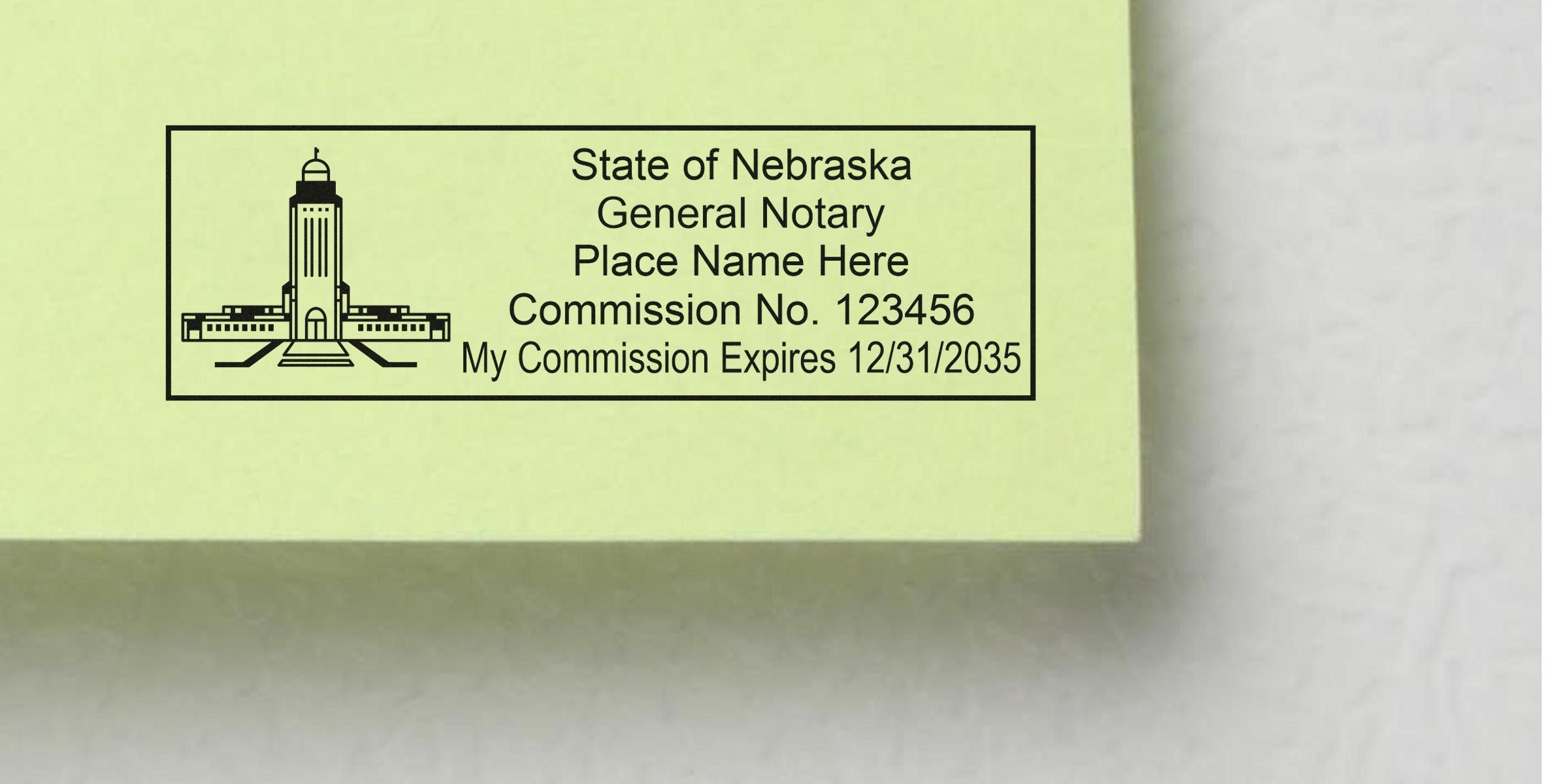 Rectangular State of Nebraska notary stamp on pale yellow paper with capitol building icon, placeholder name, commission number 123456 and expiration date 12/31/2035.