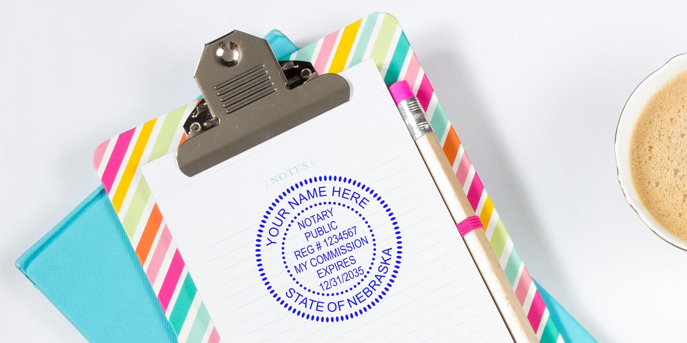 Notary stamp mockup on lined paper clipped to a colorful striped clipboard with a wooden pencil and cup of coffee, close-up desk image
