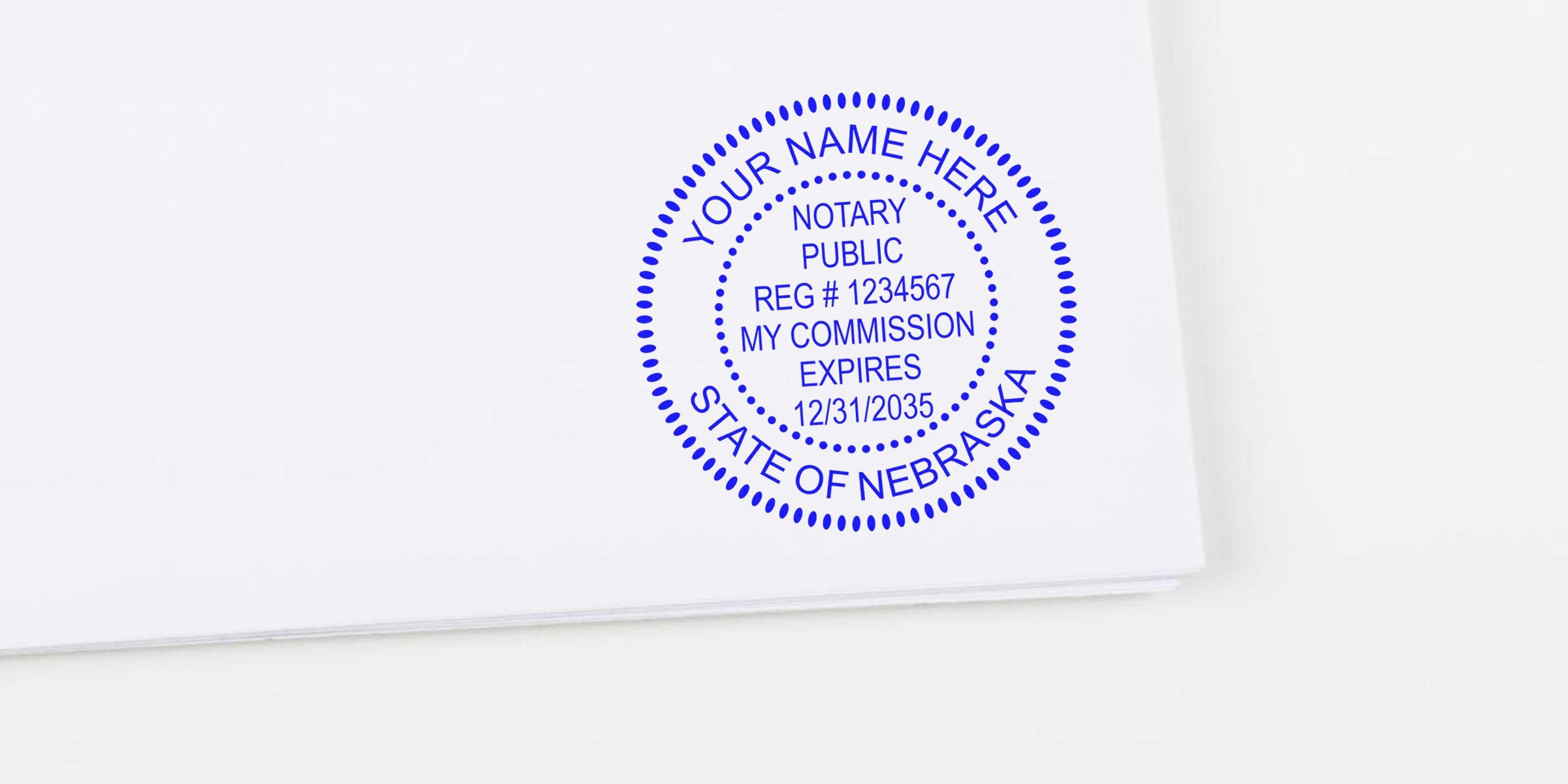 Blue circular notary public stamp on white paper reading "Your Name Here" and "State of Nebraska" with sample registration number and commission expiration date.
