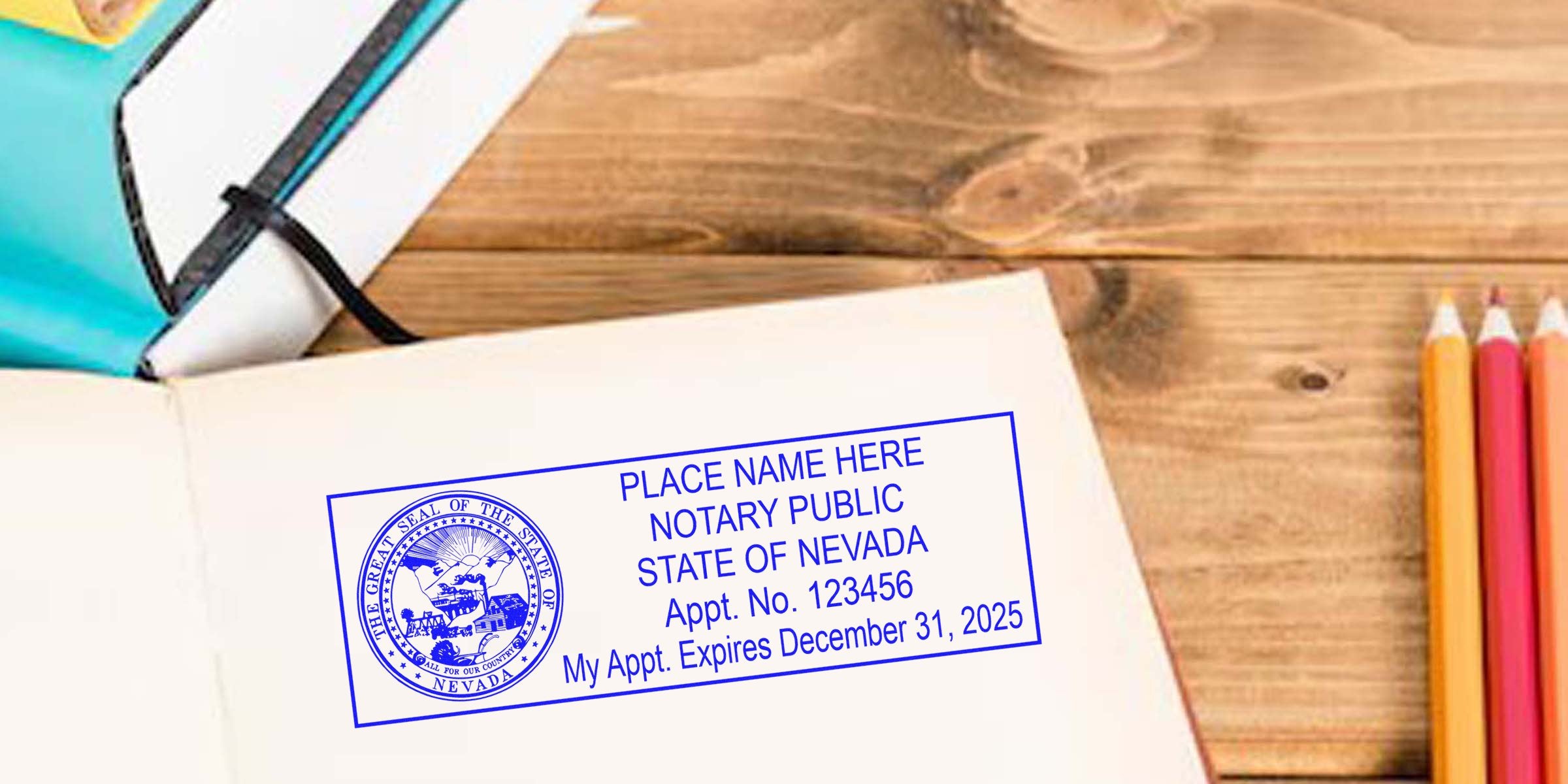 Open notebook on wooden desk showing blue "Notary Public State of Nevada" stamp imprint template, with colored pencils and a pen nearby.