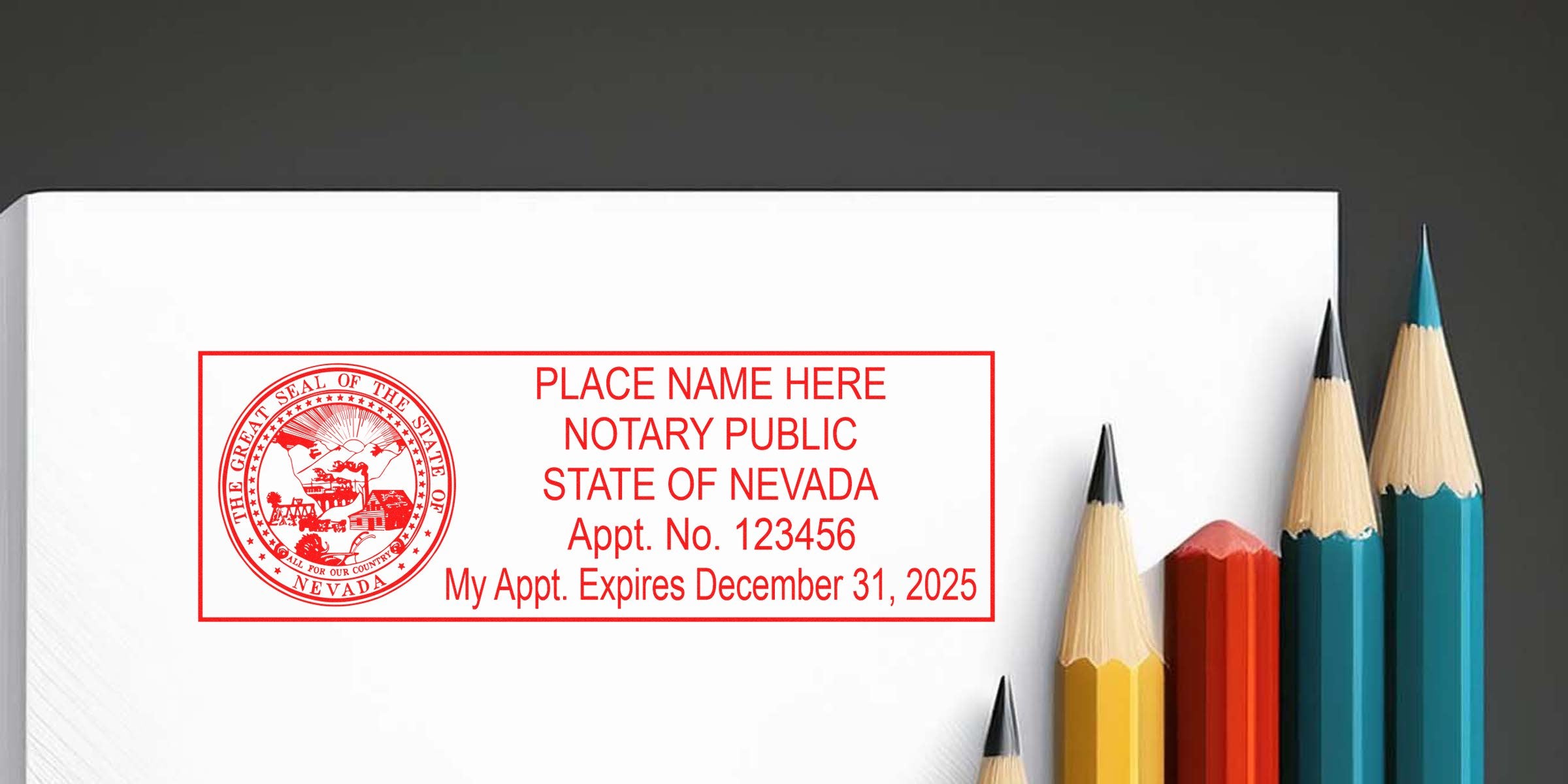 Red Nevada notary public stamp imprint on white envelope showing state seal and appointment info, photographed beside sharpened colored pencils (yellow, red, teal) on dark background