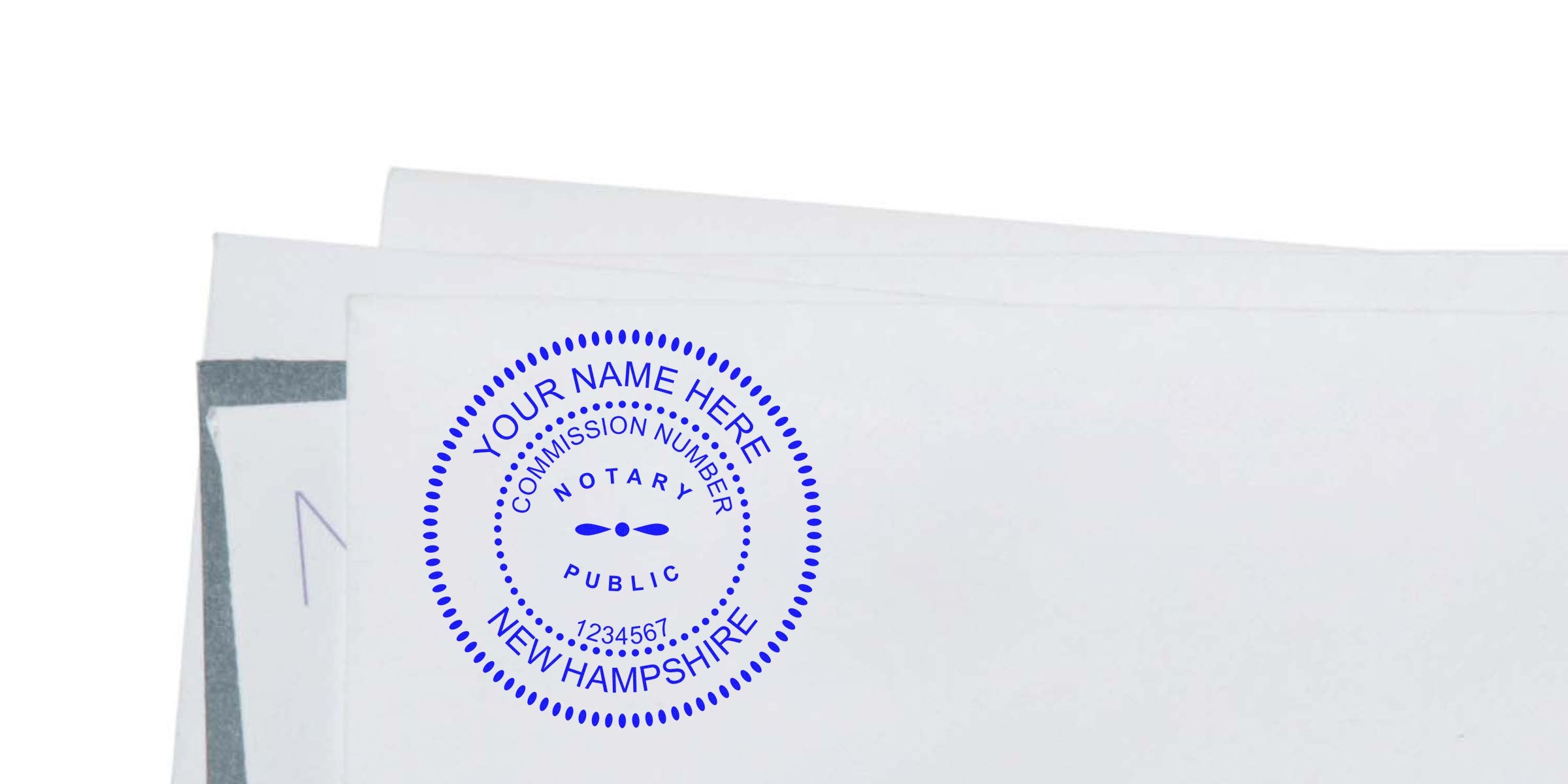 Blue circular notary public rubber stamp seal reading "Your Name Here, Commission Number, Notary Public, New Hampshire" imprinted on white envelopes