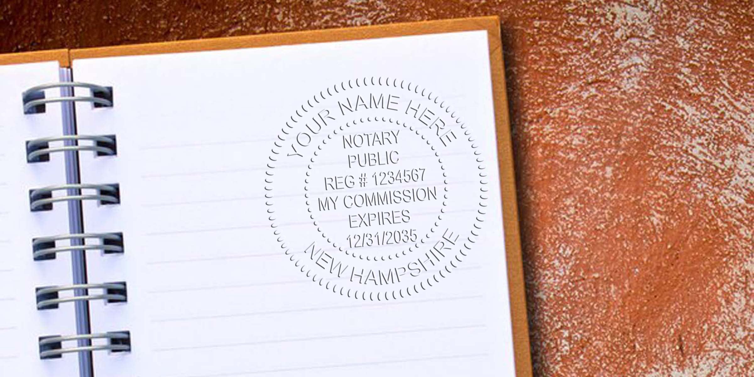Embossed notary public seal reading "Your Name Here, Notary Public, Reg #1234567, My Commission Expires 12/31/2035, New Hampshire" impressed on a blank lined spiral notebook page next to a textured brown surface.