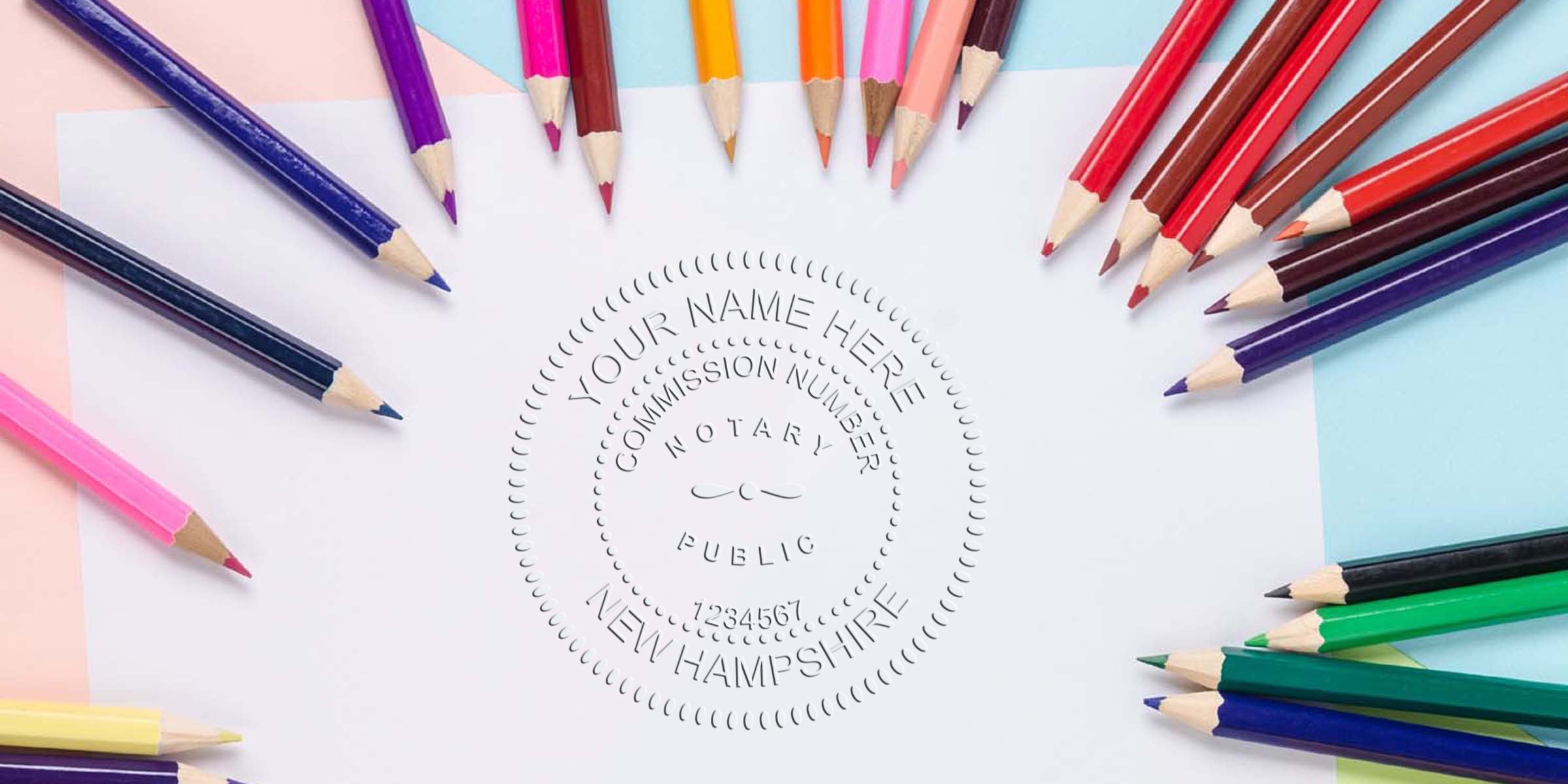 Flat lay of colorful sharpened pencils fanned around white paper with an embossed New Hampshire notary public seal, stationery and craft concept