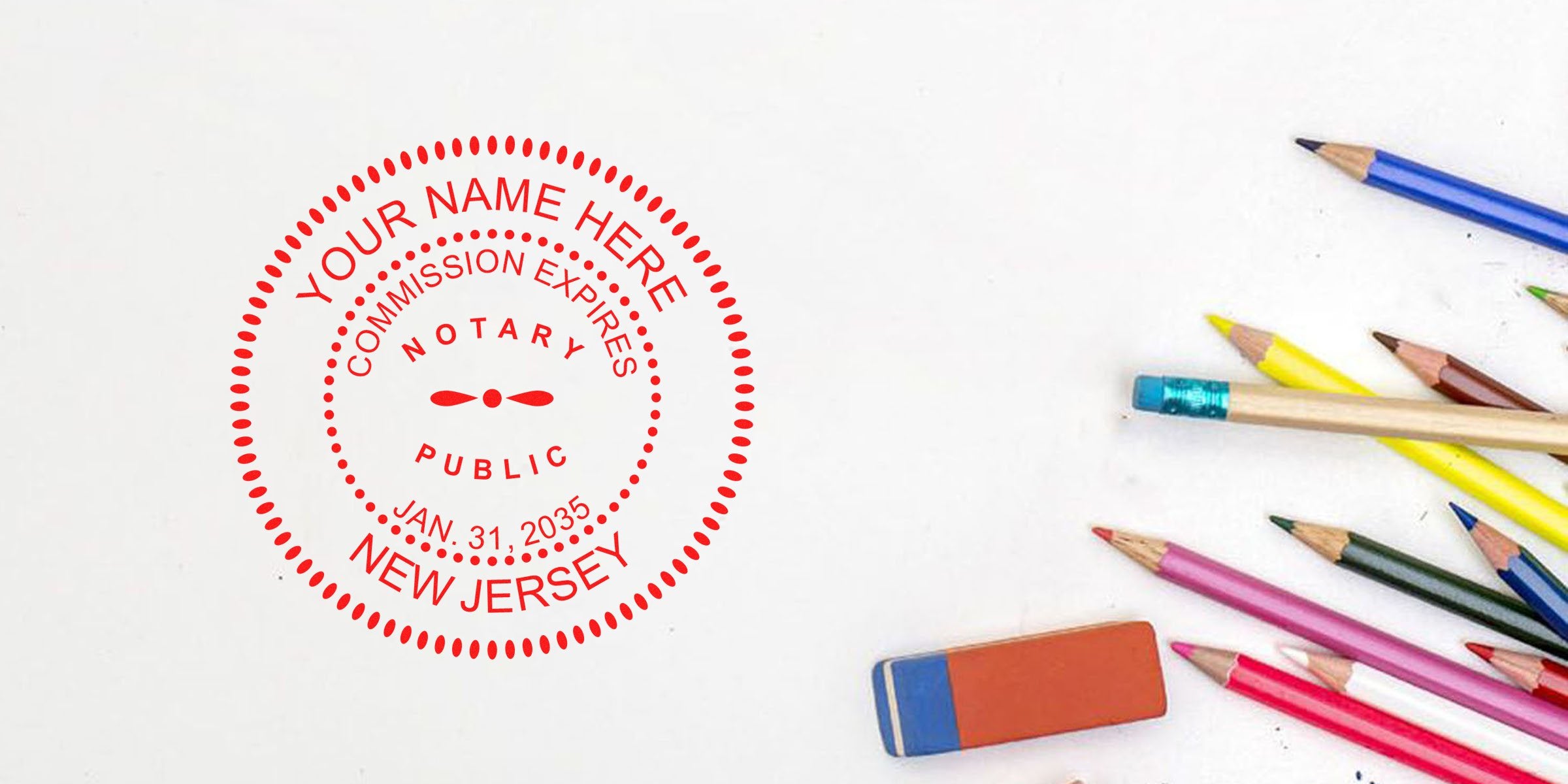 Red circular New Jersey notary public stamp mockup reading "Your Name Here" and expiration date on white paper, beside scattered colored pencils and orange/blue eraser — office stationery, notary seal and document preparation concept.