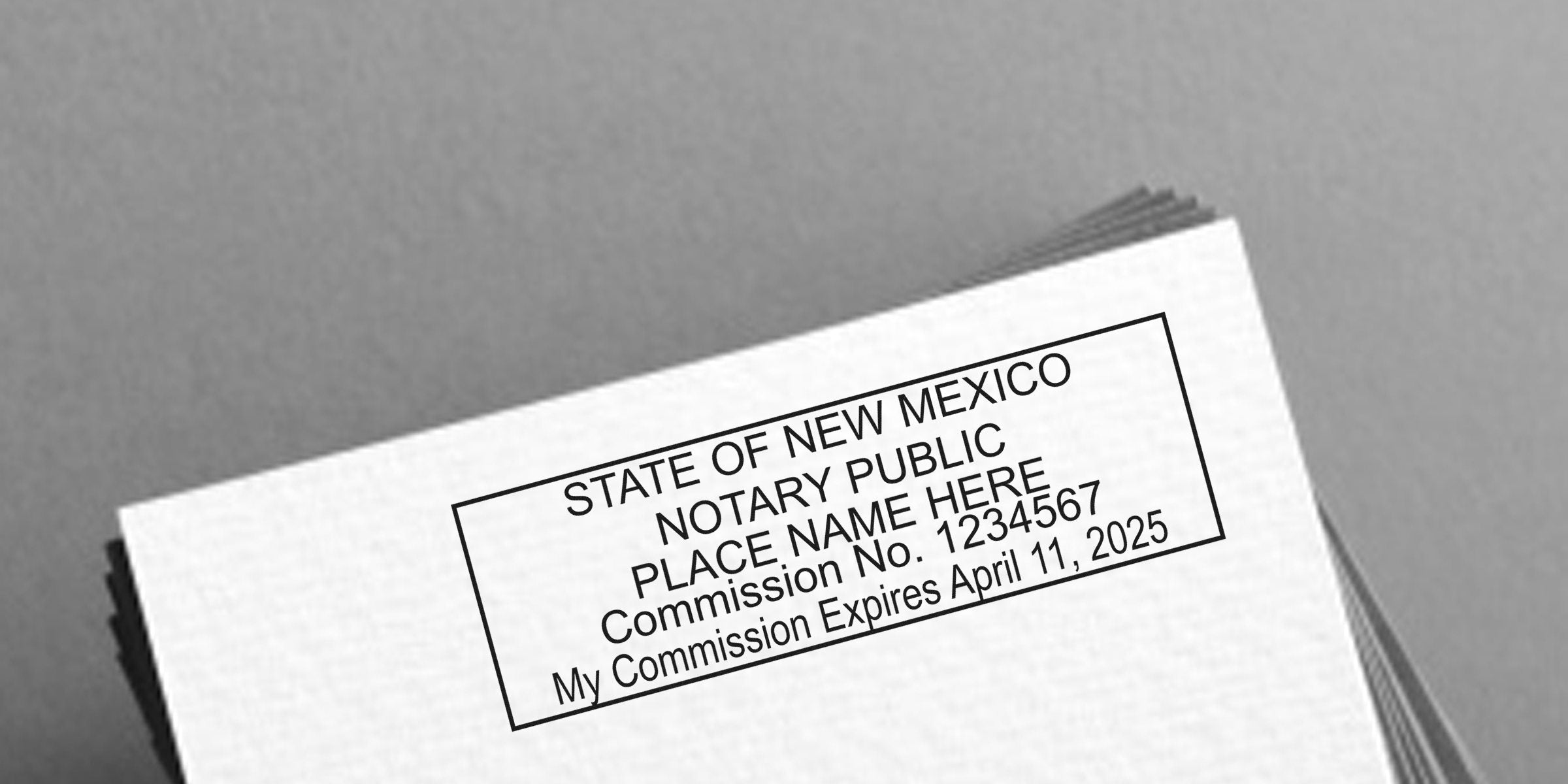 Close-up of a rectangular notary public stamp on paper reading "State of New Mexico Notary Public, Place Name Here, Commission No. 1234567, My Commission Expires April 11, 2025."