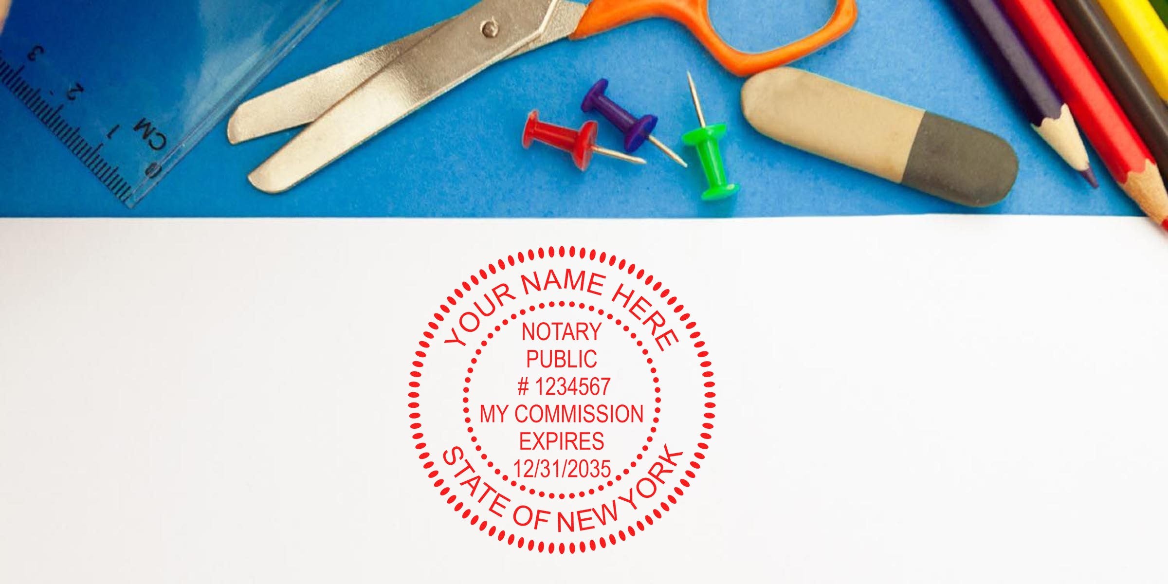 Red circular New York notary public stamp on white paper with ruler, scissors, push pins, eraser and colored pencils on blue background, office/school supplies.