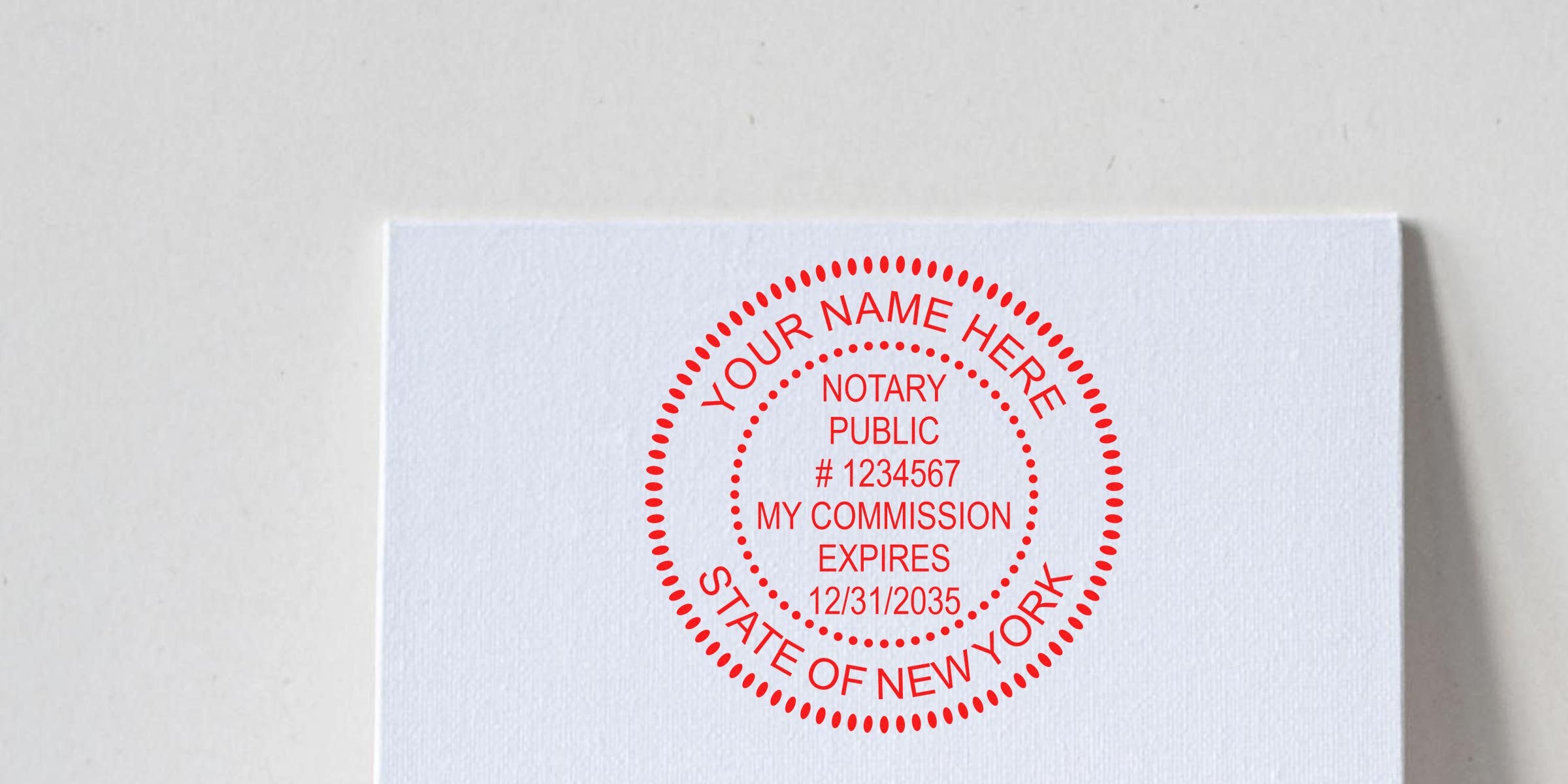Red circular New York notary public stamp on white textured paper reading "Your Name Here", notary public, #1234567, "My Commission Expires 12/31/2035"