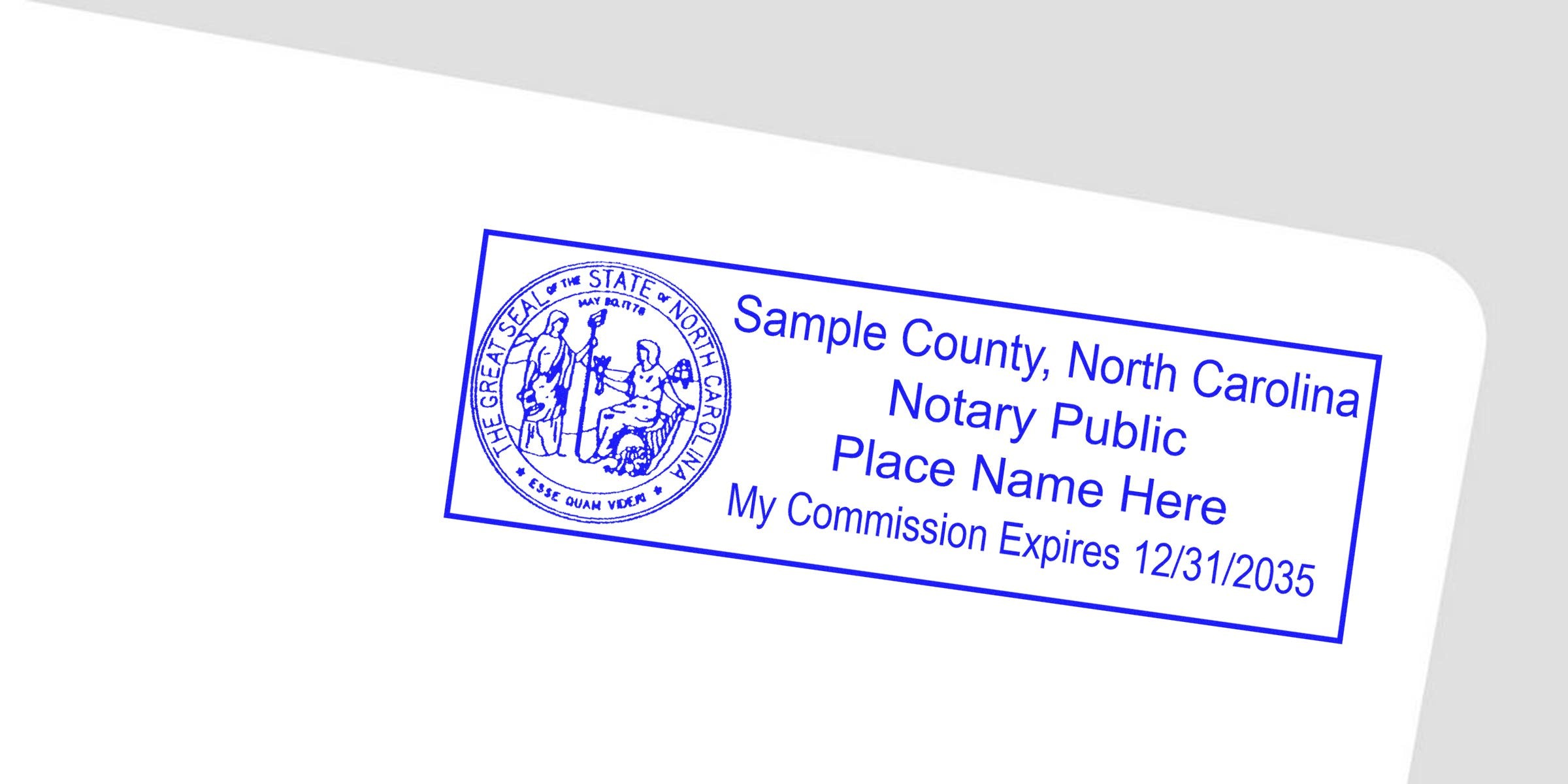 Blue rectangular notary stamp angled on white background featuring the North Carolina state seal and placeholder text: "Sample County, North Carolina Notary Public Place Name Here My Commission Expires 12/31/2035."