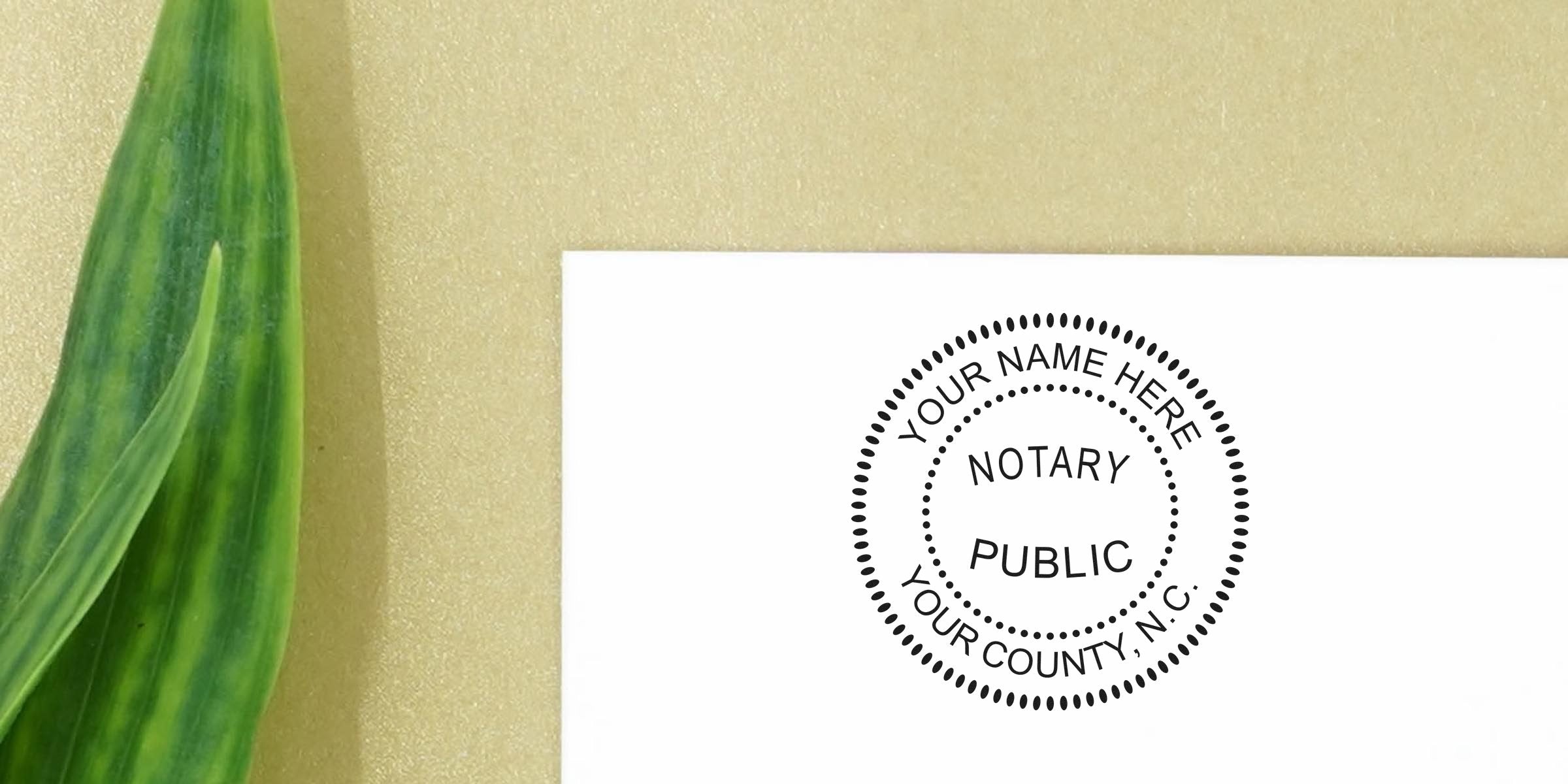 Minimalist notary public round stamp mockup on white card with "Notary Public" text, gold textured background and green leaf accent — custom notary seal design idea