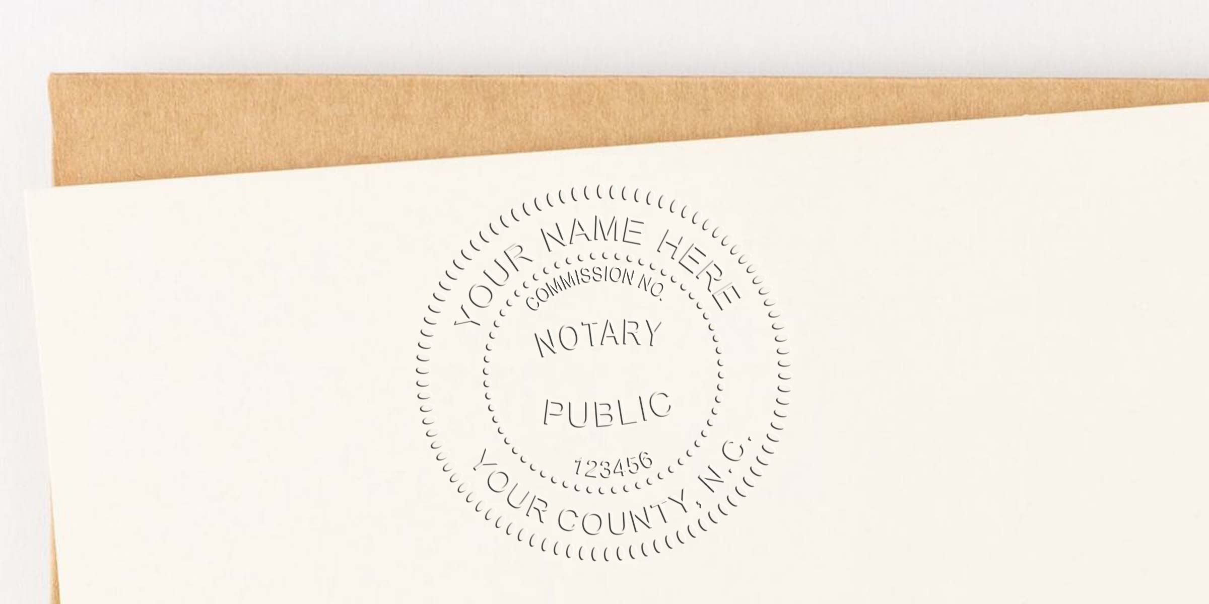 Embossed notary public seal on cream stationery featuring circular stamp design with placeholder text "Your Name Here," commission number and county, shown alongside a kraft envelope