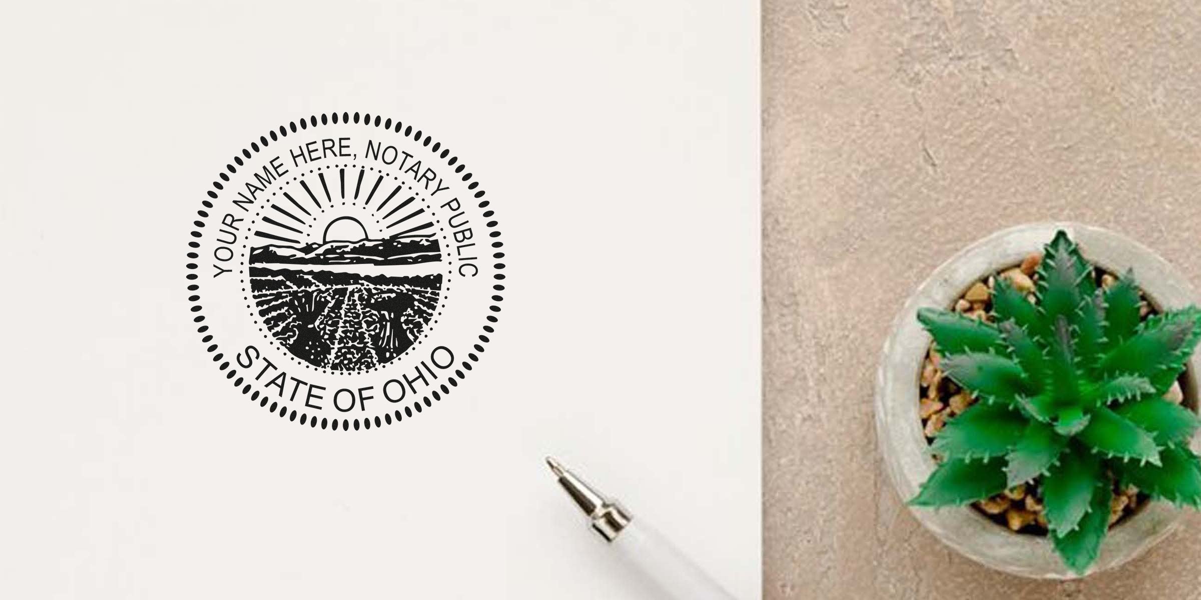 Close-up of State of Ohio notary public seal stamped on paper beside a white pen and small potted succulent on a beige desk