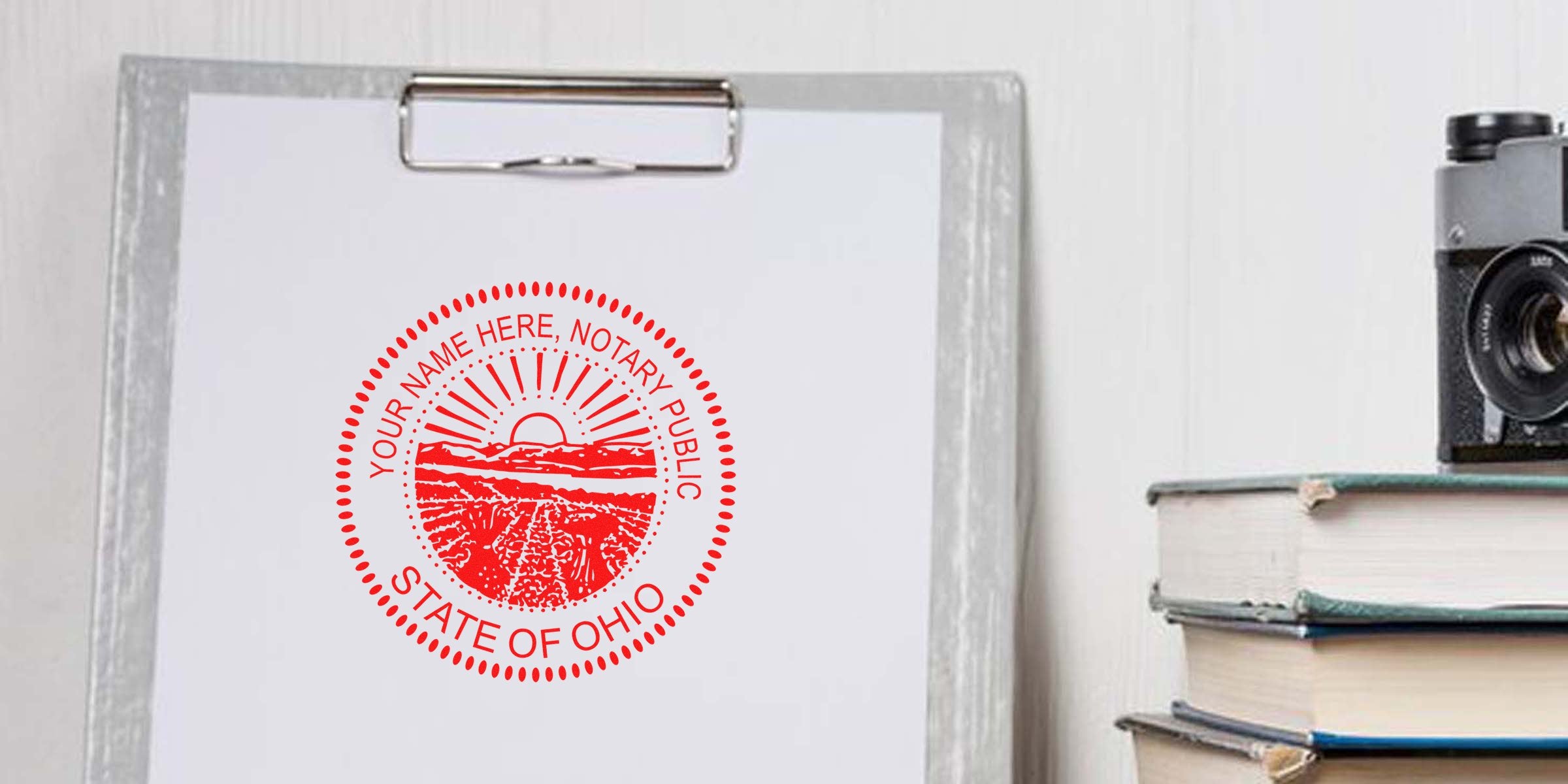 Clipboard with white paper stamped by a red circular "Notary Public State of Ohio" seal, vintage camera and stacked books on a table
