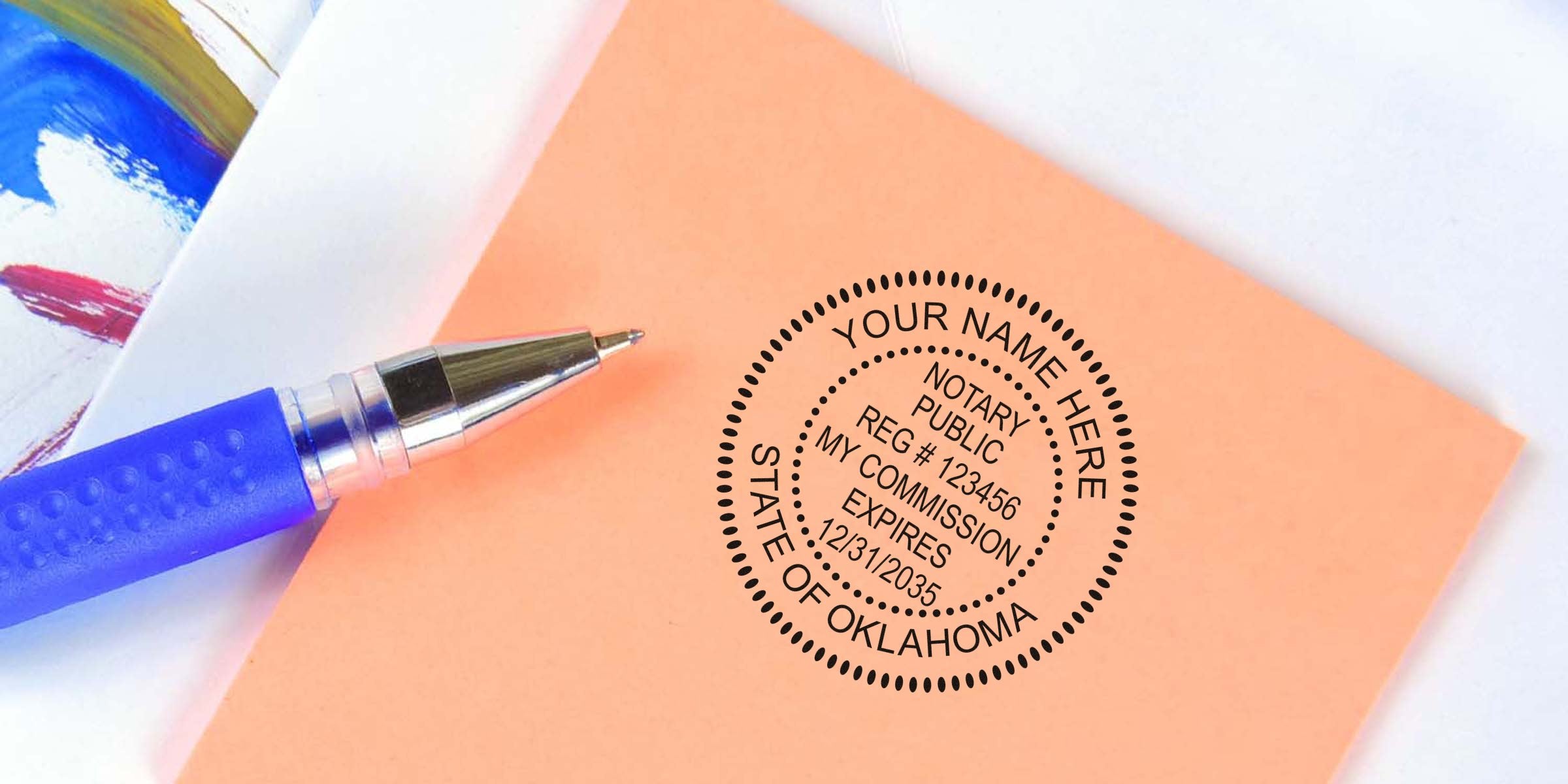 Custom Oklahoma notary stamp mockup reading "Your Name Here" round seal on peach paper with blue pen, notary public stamp design