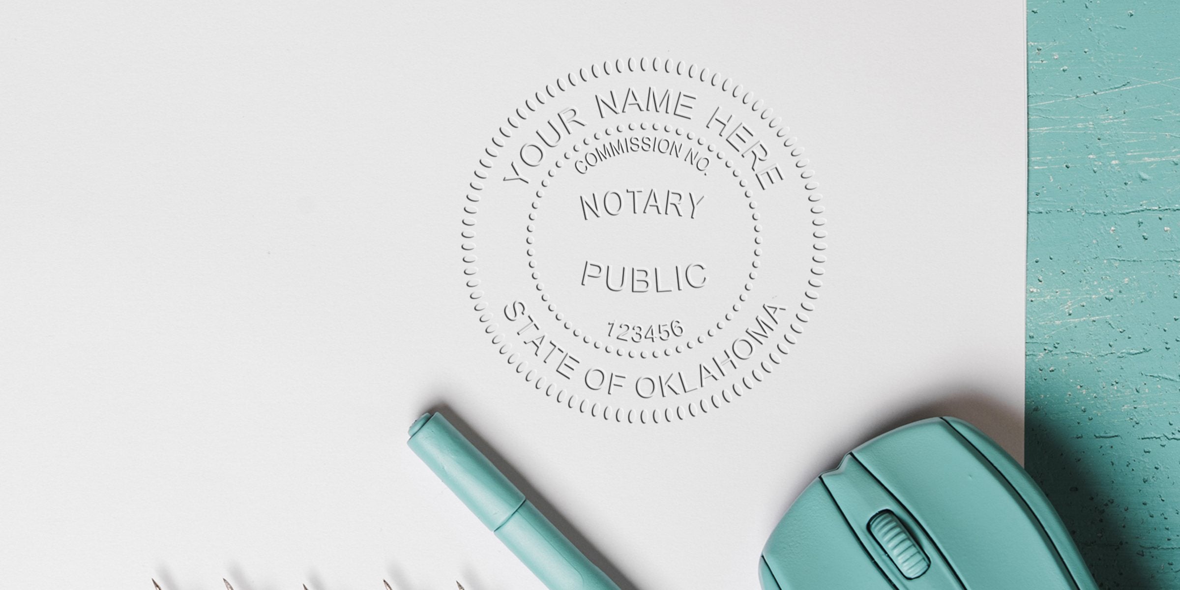 Embossed Notary Public seal for State of Oklahoma on white paper with a teal pen and wireless mouse on a turquoise wooden surface — business stationery concept for notarization, documents, and legal services