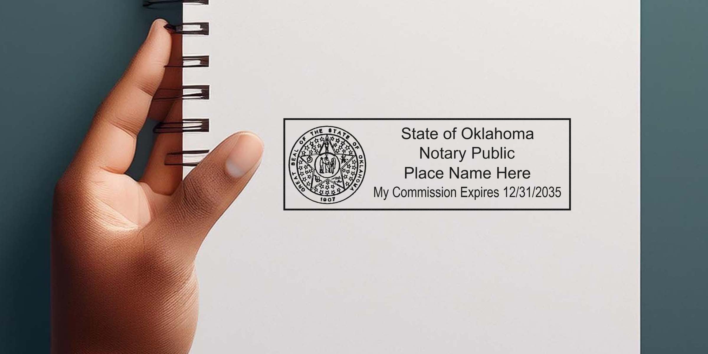 Close-up of a hand holding a spiral notebook showing an Oklahoma notary public stamp and text "State of Oklahoma Notary Public, Place Name Here, My Commission Expires 12/31/2035"