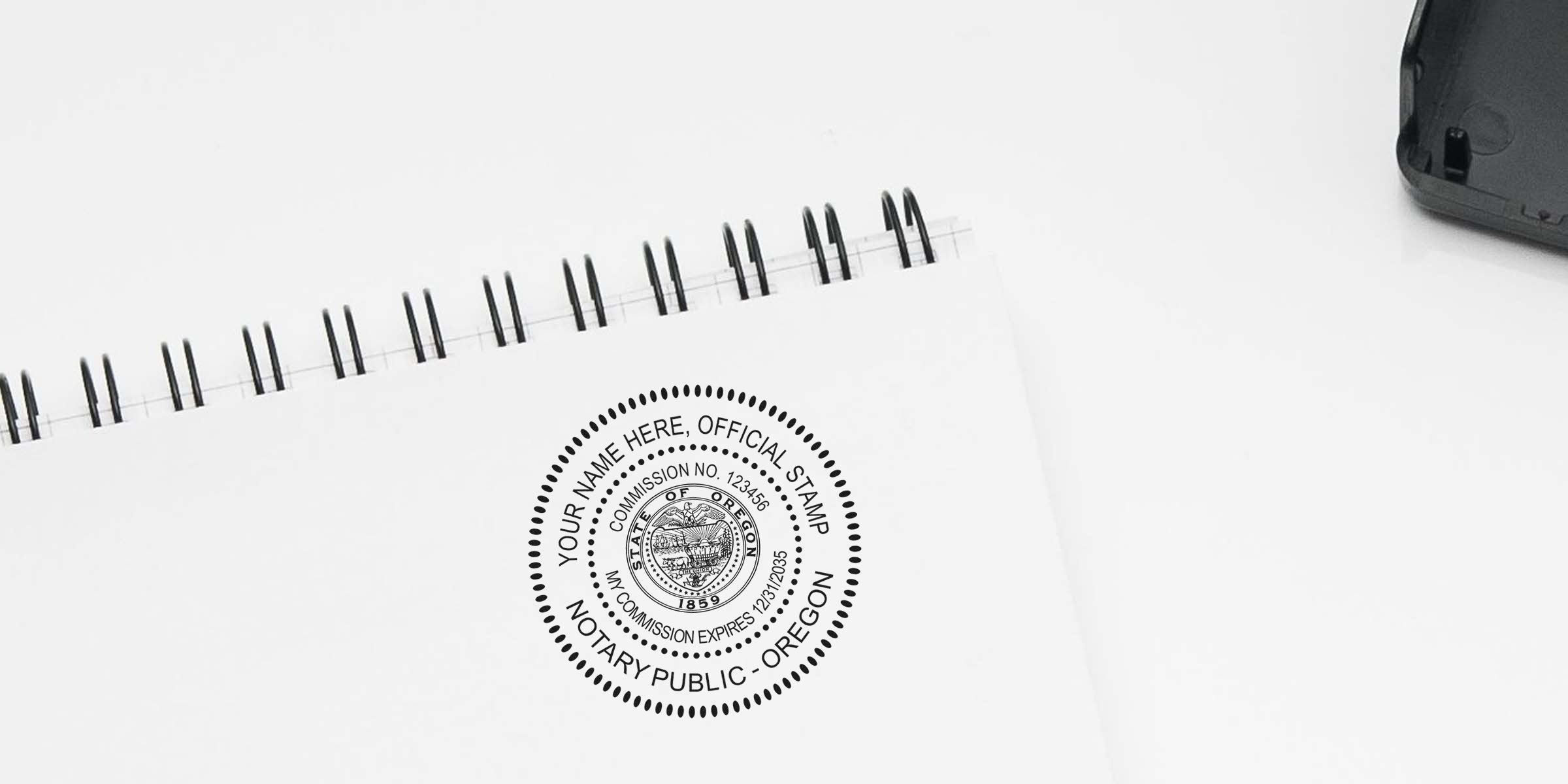 Round Oregon notary public stamp impression on white spiral-bound notebook page, black circular seal with state emblem and placeholder text for name, commission number and expiration date