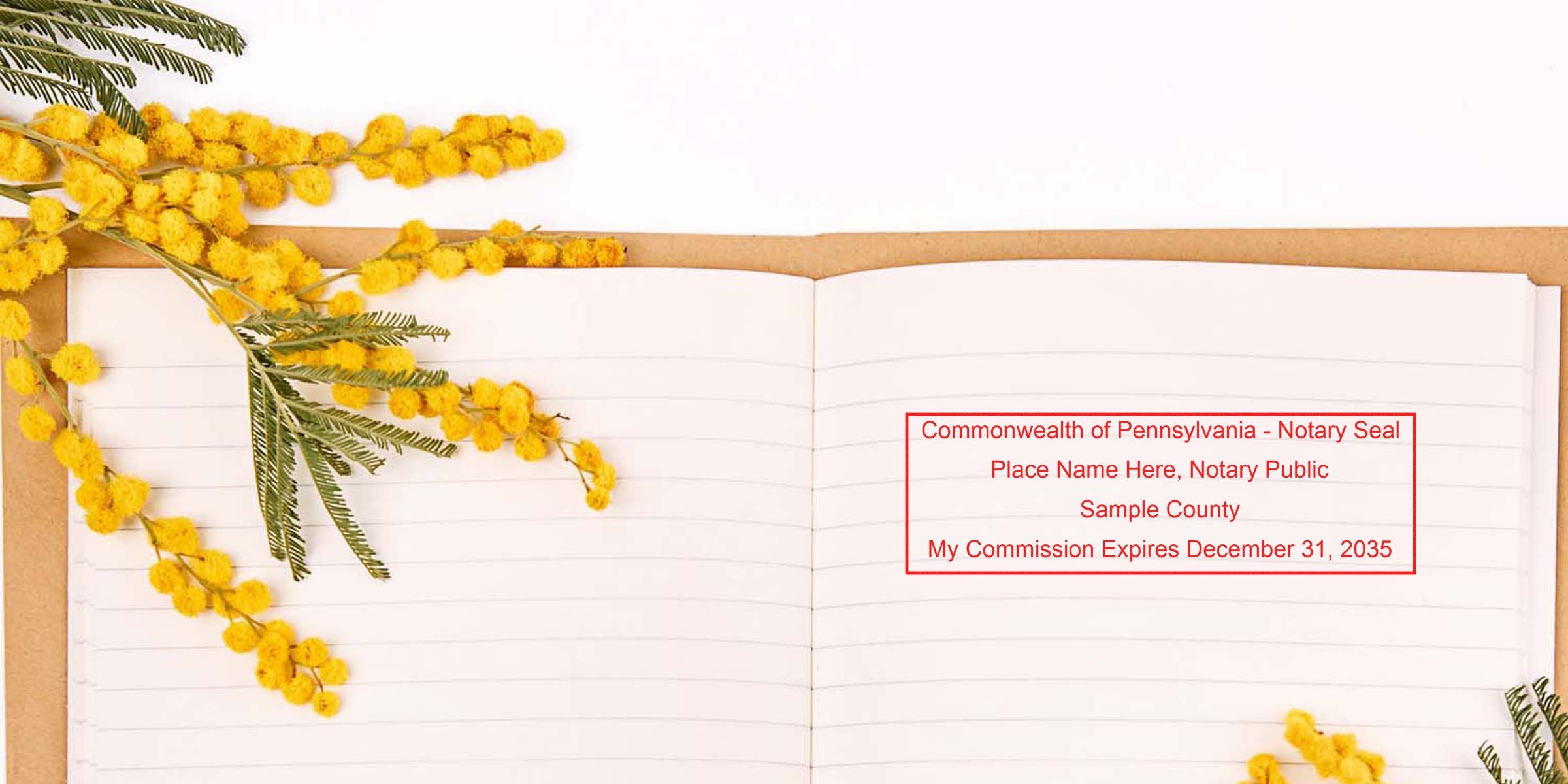 Flat lay of open lined notebook with yellow mimosa sprigs and red sample notary seal stamp reading "Commonwealth of Pennsylvania - Notary Seal" for stationery.