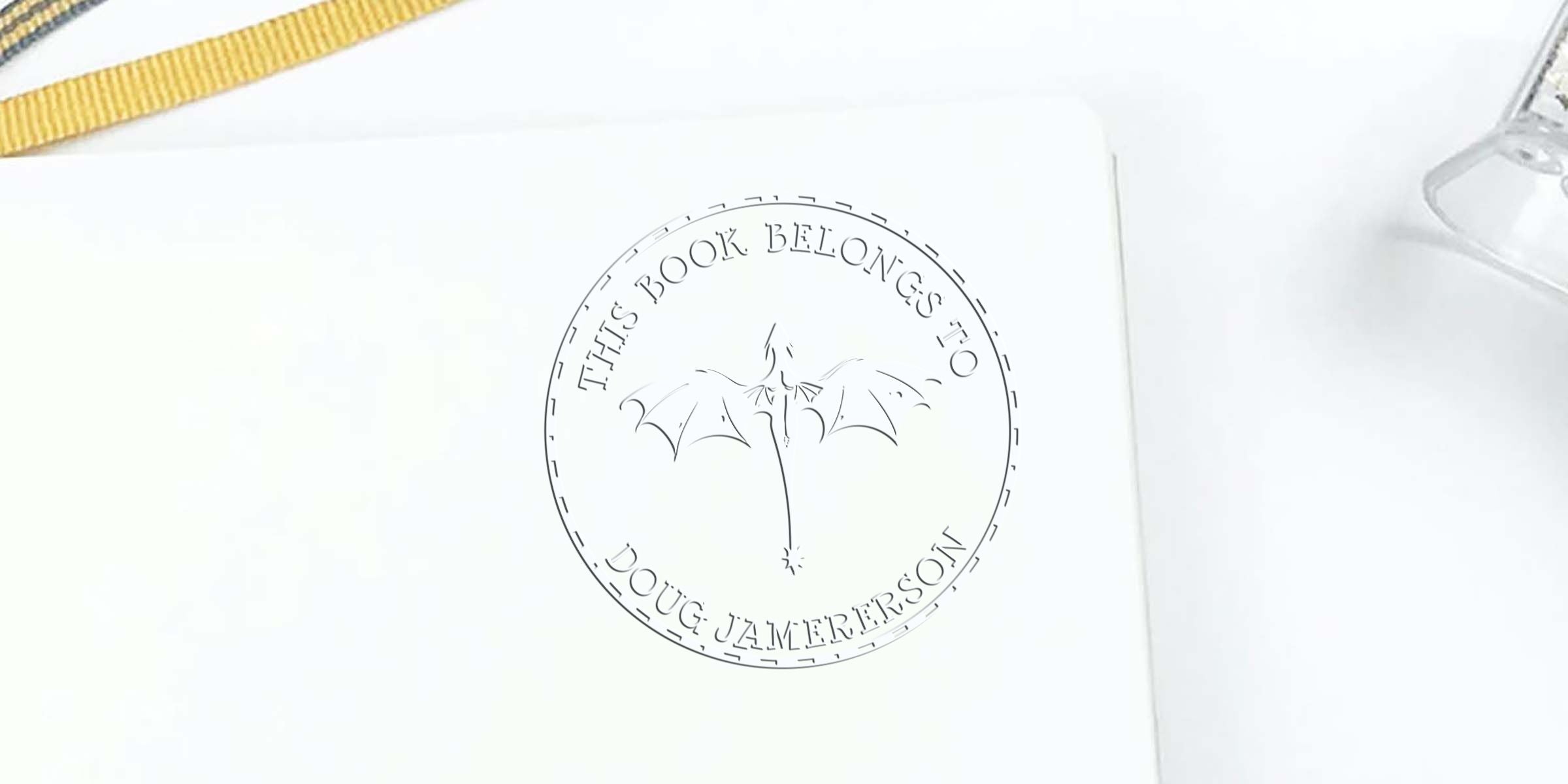 Circular stamp reading “This book belongs to Doug Zamerson” with a palm-tree-and-dragon graphic in the center.