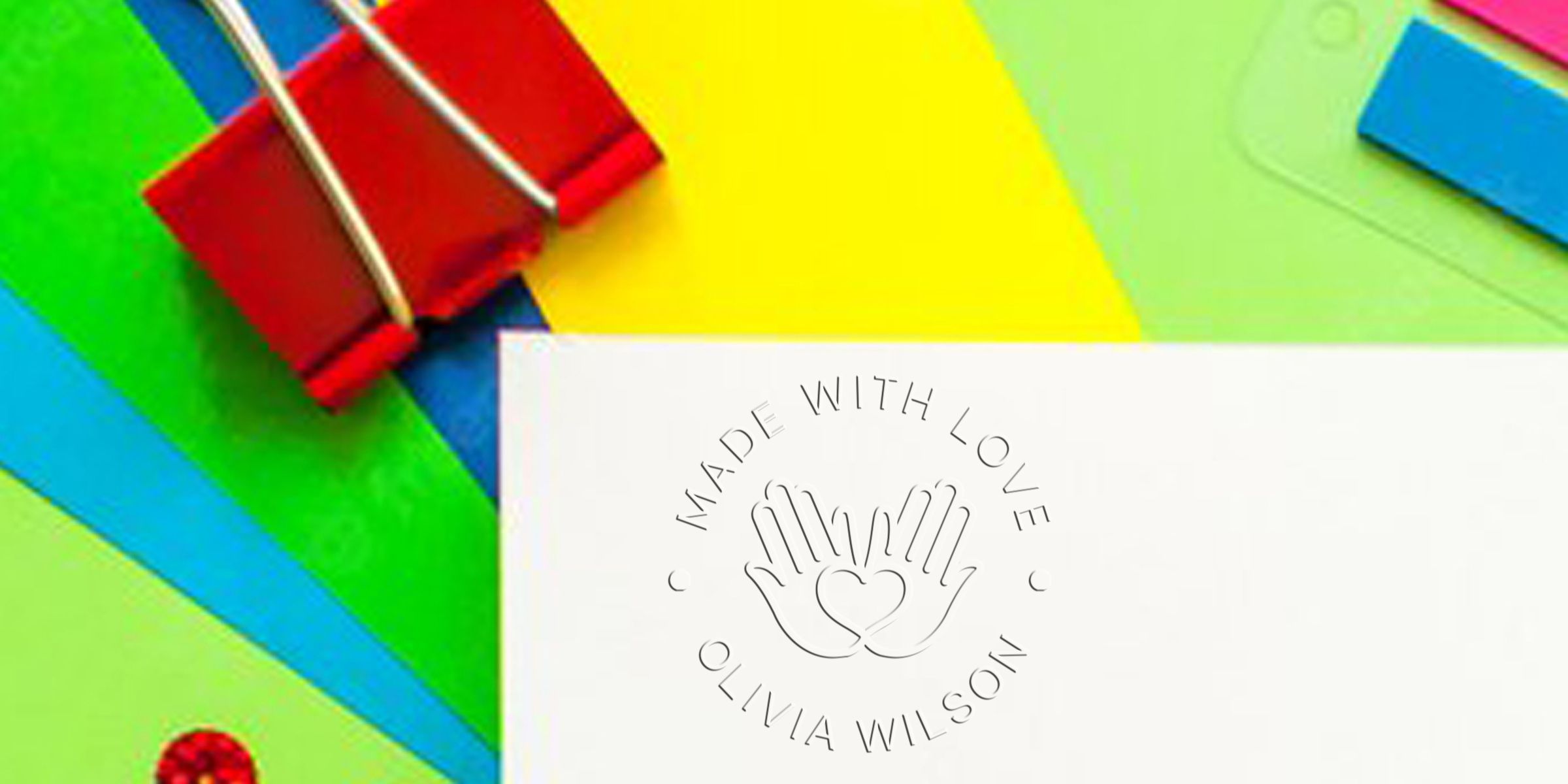Bright, colorful background with a white card displaying a circular "Made with Love" logo featuring hands forming a heart and the name Olivia Wilson.