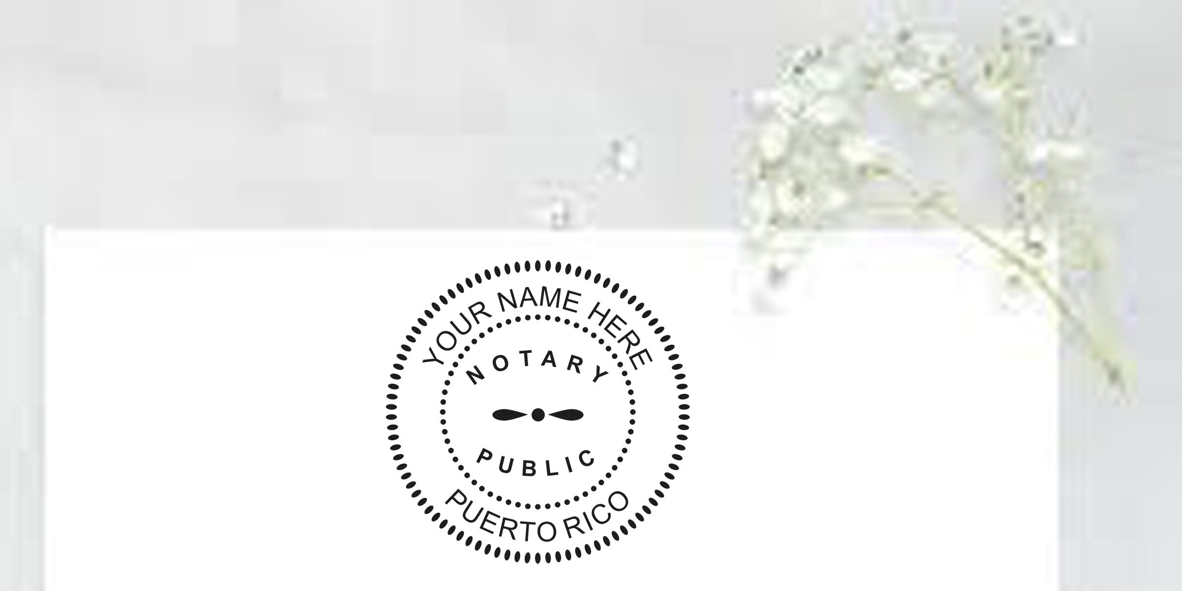 Round notary public rubber stamp mockup reading "Your Name Here – Notary Public – Puerto Rico" printed on white stationery, with a delicate baby's-breath flower accent in the top-right corner.