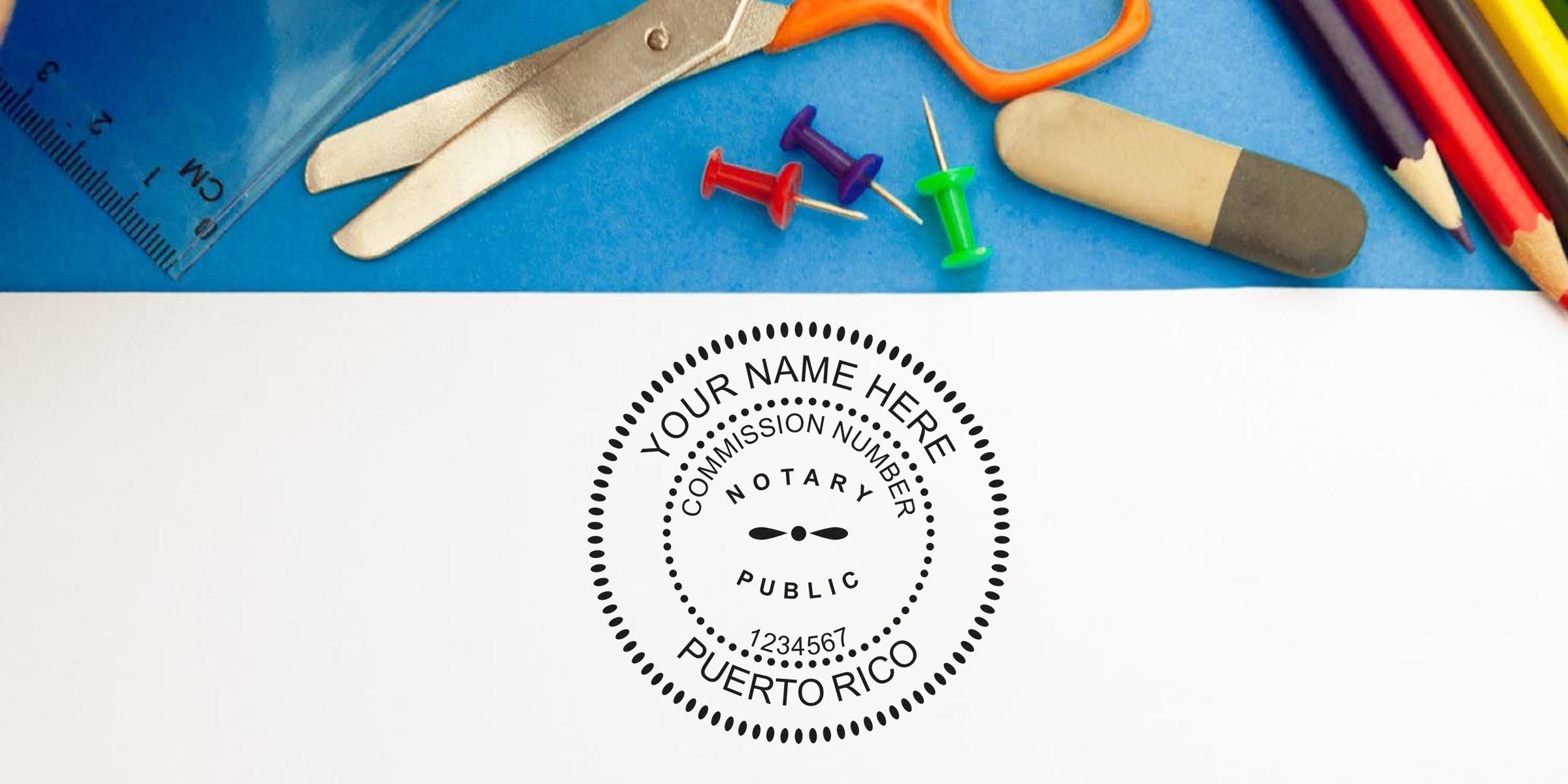 Top view of a notary public seal mockup reading "Your Name Here, Puerto Rico" stamped on white paper, surrounded by scissors, ruler, colored pencils, eraser and colorful push pins on a blue background — customizable notary stamp concept.