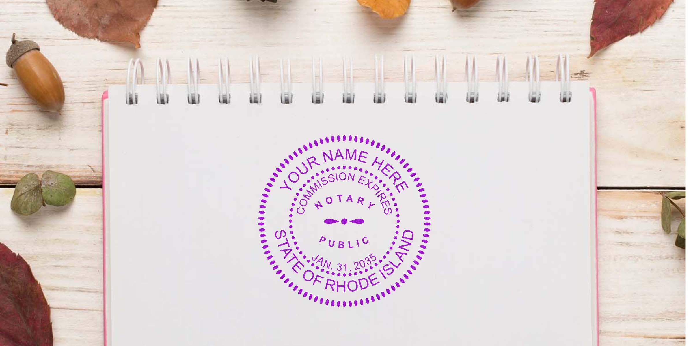 Spiral notebook on light wooden table with autumn leaves and acorn, featuring a purple circular notary public stamp reading "State of Rhode Island" with placeholder "Your Name Here."
