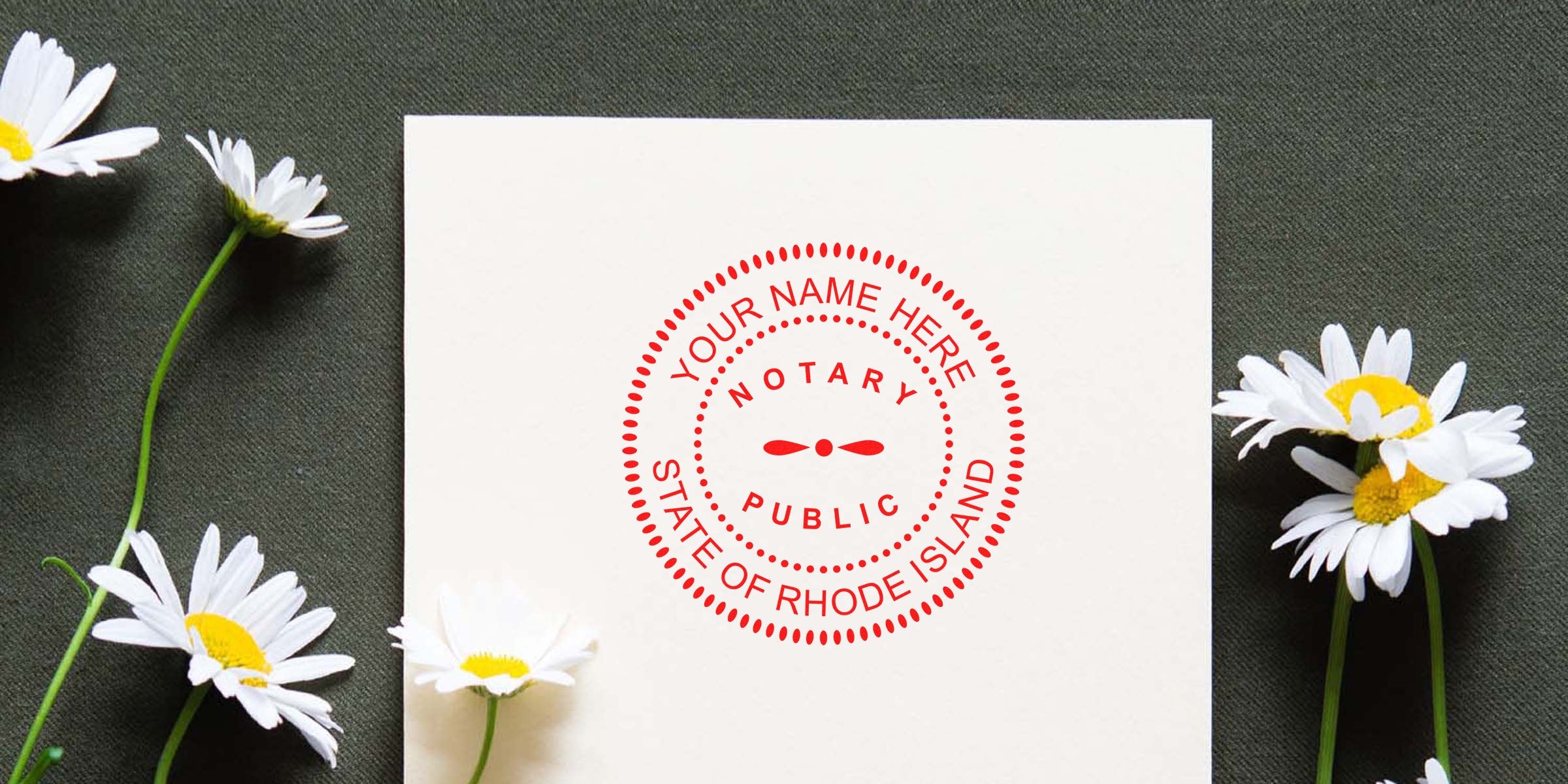 Flat-lay of a white card featuring a red "Notary Public State of Rhode Island" circular seal mockup, placed among white daisies on dark fabric background.