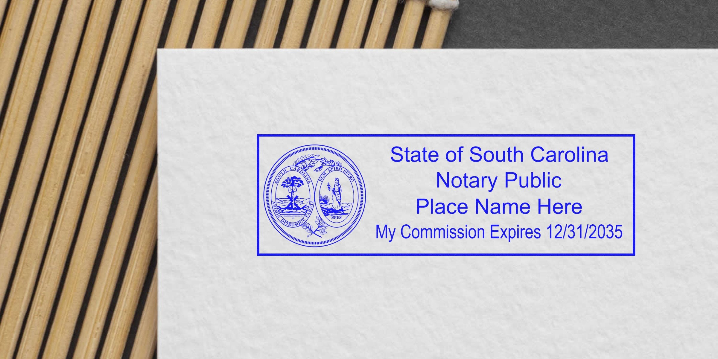 Blue rectangular State of South Carolina notary public stamp on textured paper featuring the state seal, placeholder name text and commission expiration date 12/31/2035