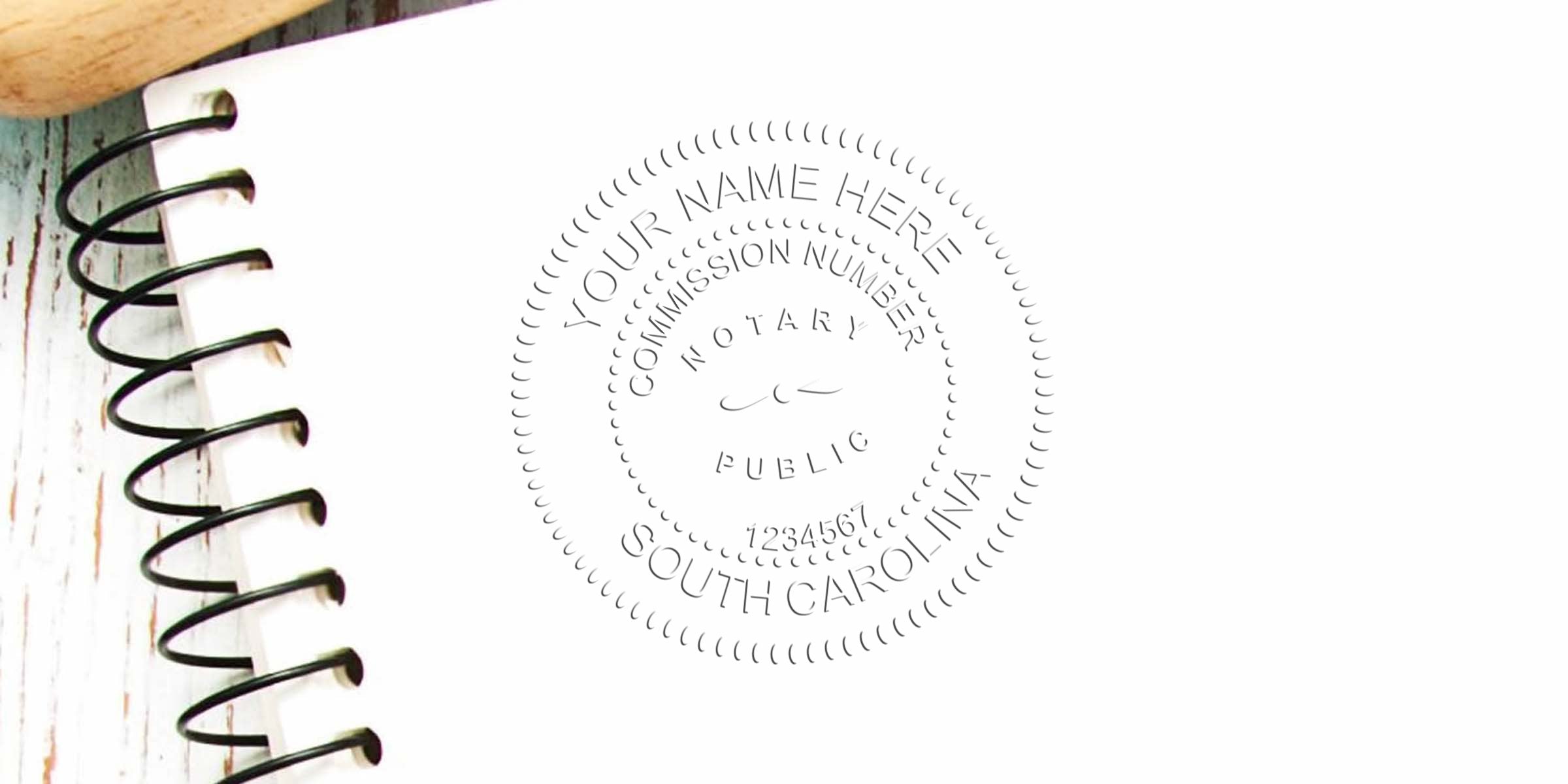 Embossed notary public seal imprint on white paper next to black spiral notebook, circular commission stamp reading "Your Name Here, South Carolina" for document authentication and notary services