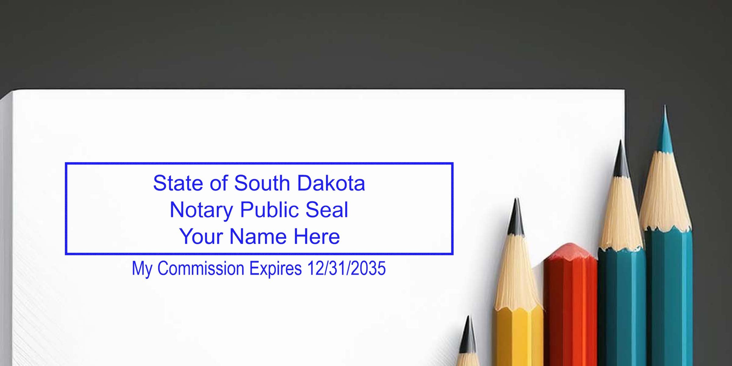 Blue rectangular "State of South Dakota Notary Public Seal" stamped on white paper beside a row of sharpened colored pencils (yellow, red, teal), text showing "My Commission Expires 12/31/2035"