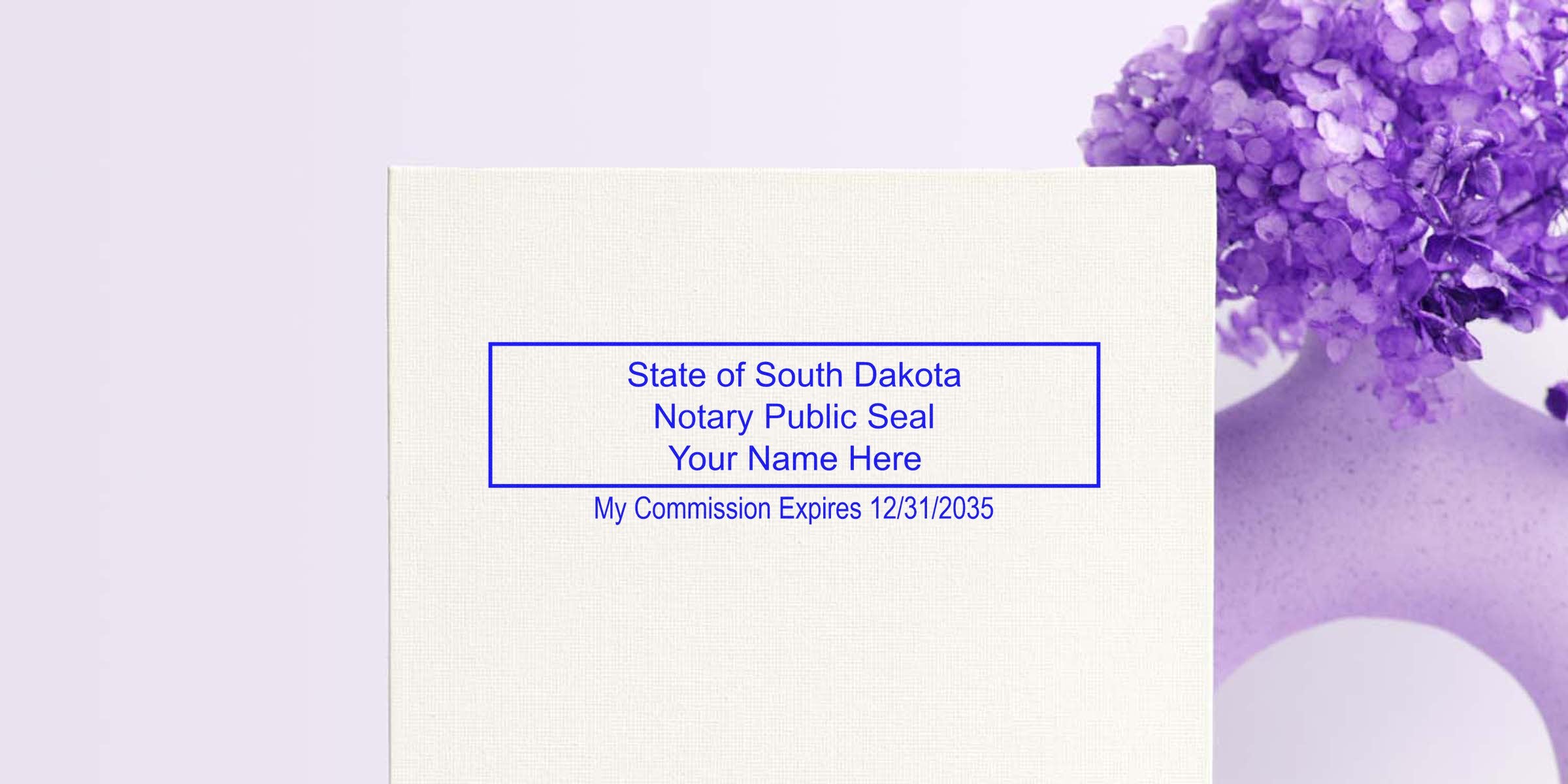 Mockup of State of South Dakota notary public seal in blue ink on textured paper reading "Your Name Here" with commission expiration date, shown next to a purple vase with flowers.