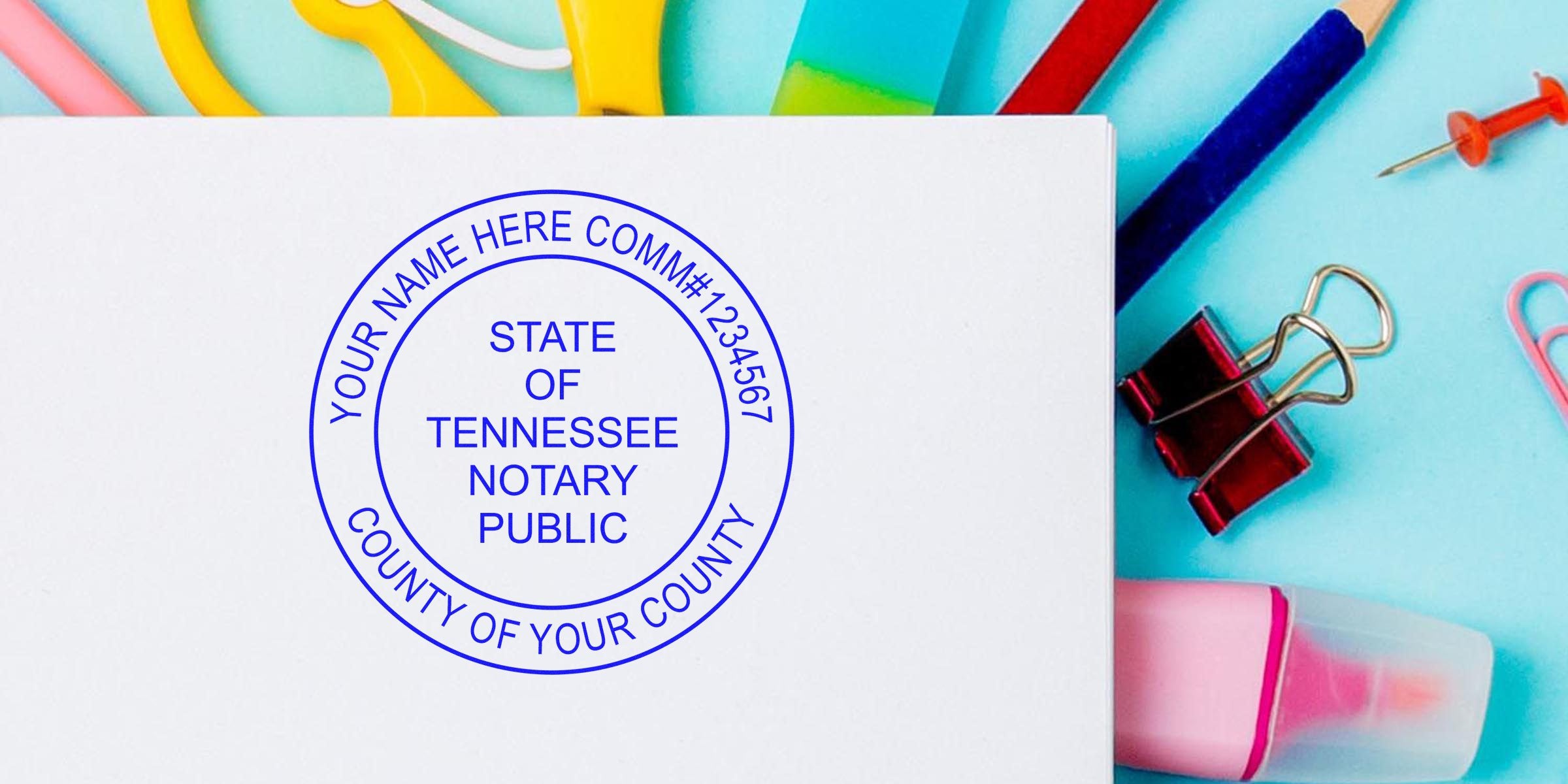 Blue circular "State of Tennessee Notary Public" stamp on white paper surrounded by colorful office supplies (clips, eraser, pushpin)
