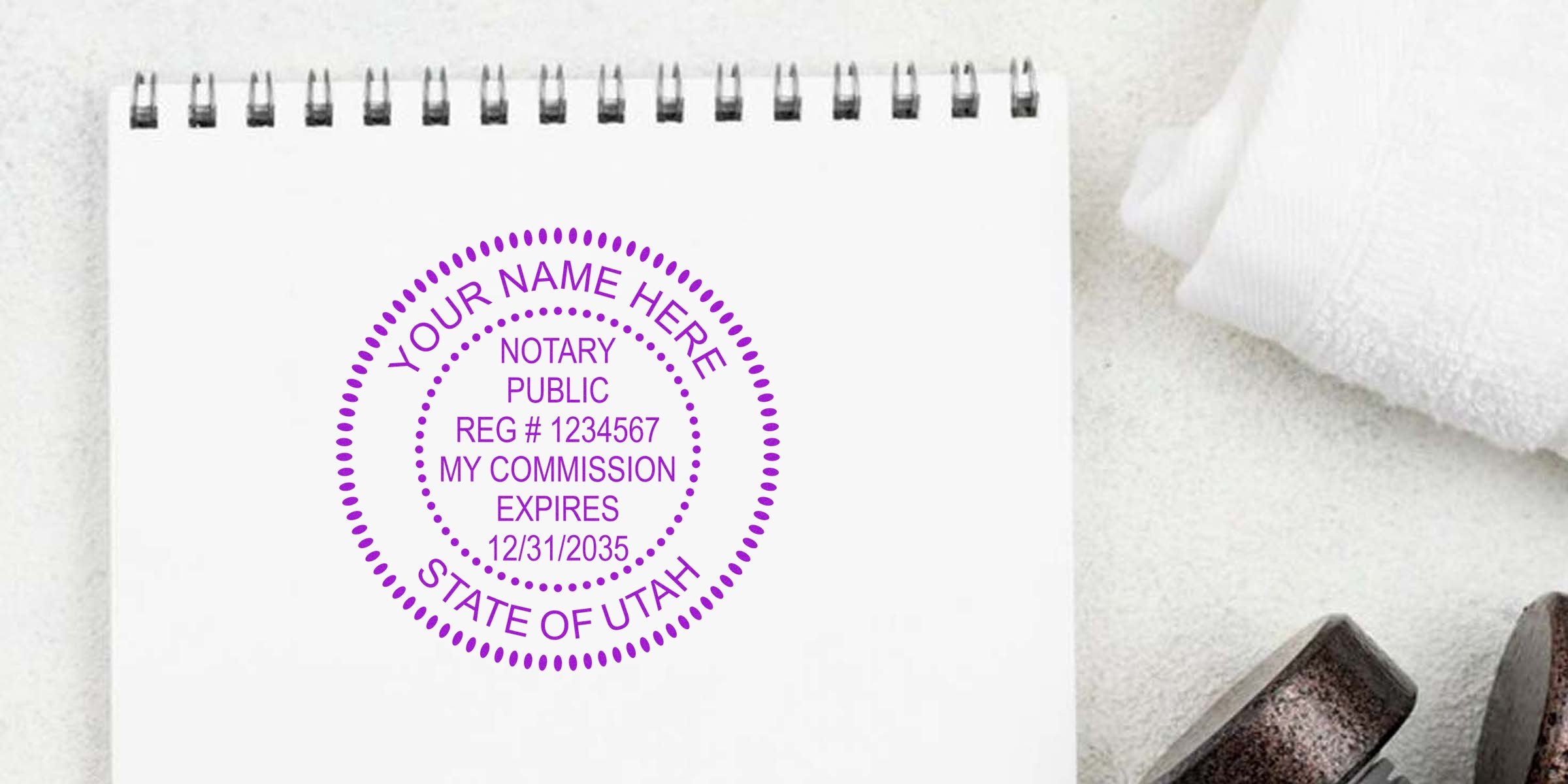 Purple circular notary public stamp mockup on a spiral notebook reading "Your Name Here, Notary Public, Reg #1234567, My Commission Expires 12/31/2035, State of Utah"