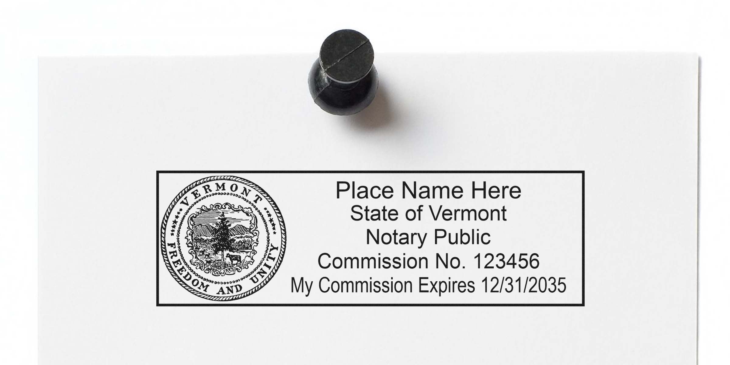 Vermont notary stamp template pinned to paper showing state seal, "Place Name Here" placeholder, Notary Public, Commission No. 123456 and commission expiration date (12/31/2035)