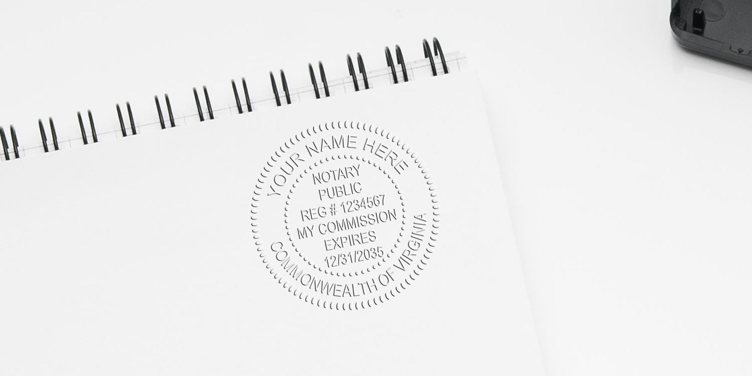 Embossed notary public seal stamped on white spiral-bound notebook, circular Virginia commission seal showing registration and expiration details