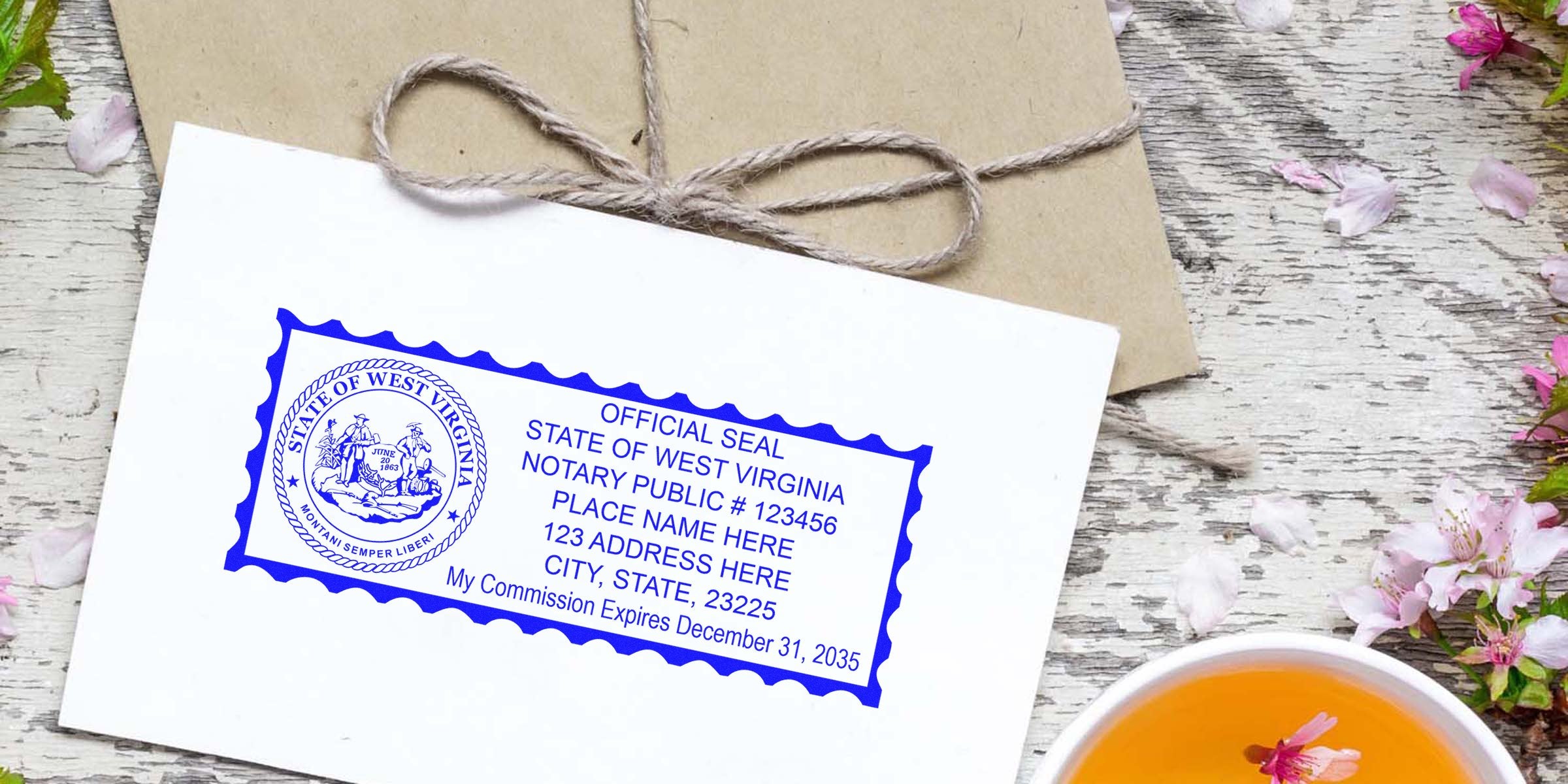 Envelope with blue Official Seal of West Virginia notary stamp on white card, rustic wooden background, twine-wrapped kraft envelope, pink blossoms and a cup of tea
