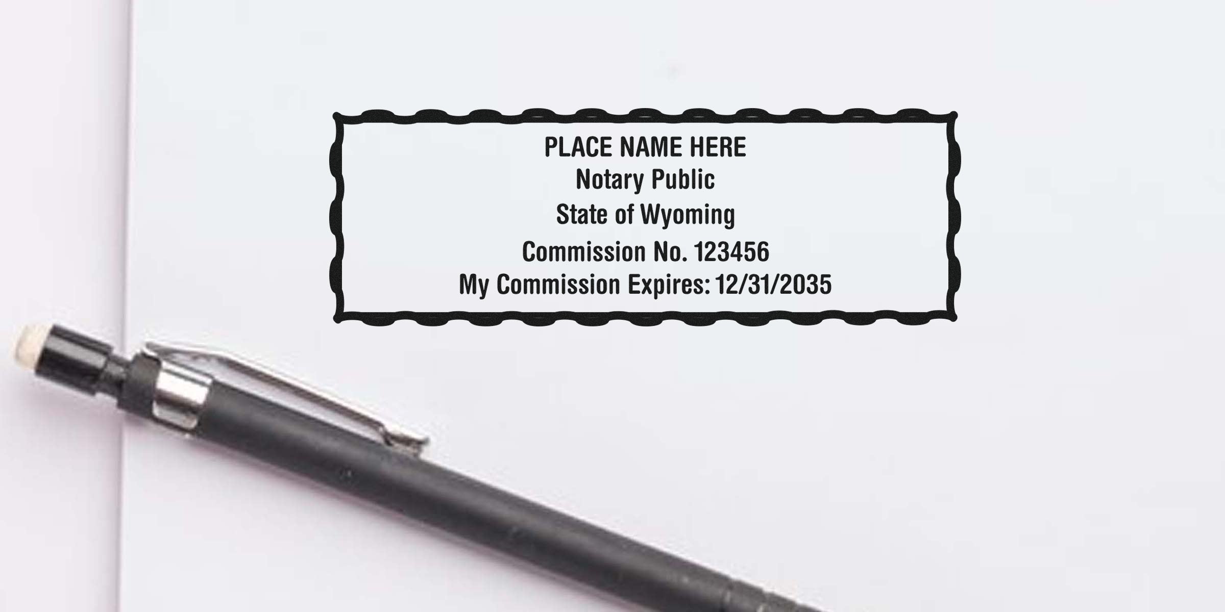 Blank notary stamp mockup on white paper reading "Place Name Here, Notary Public, State of Wyoming, Commission No. 123456, My Commission Expires: 12/31/2035" with black pen nearby.