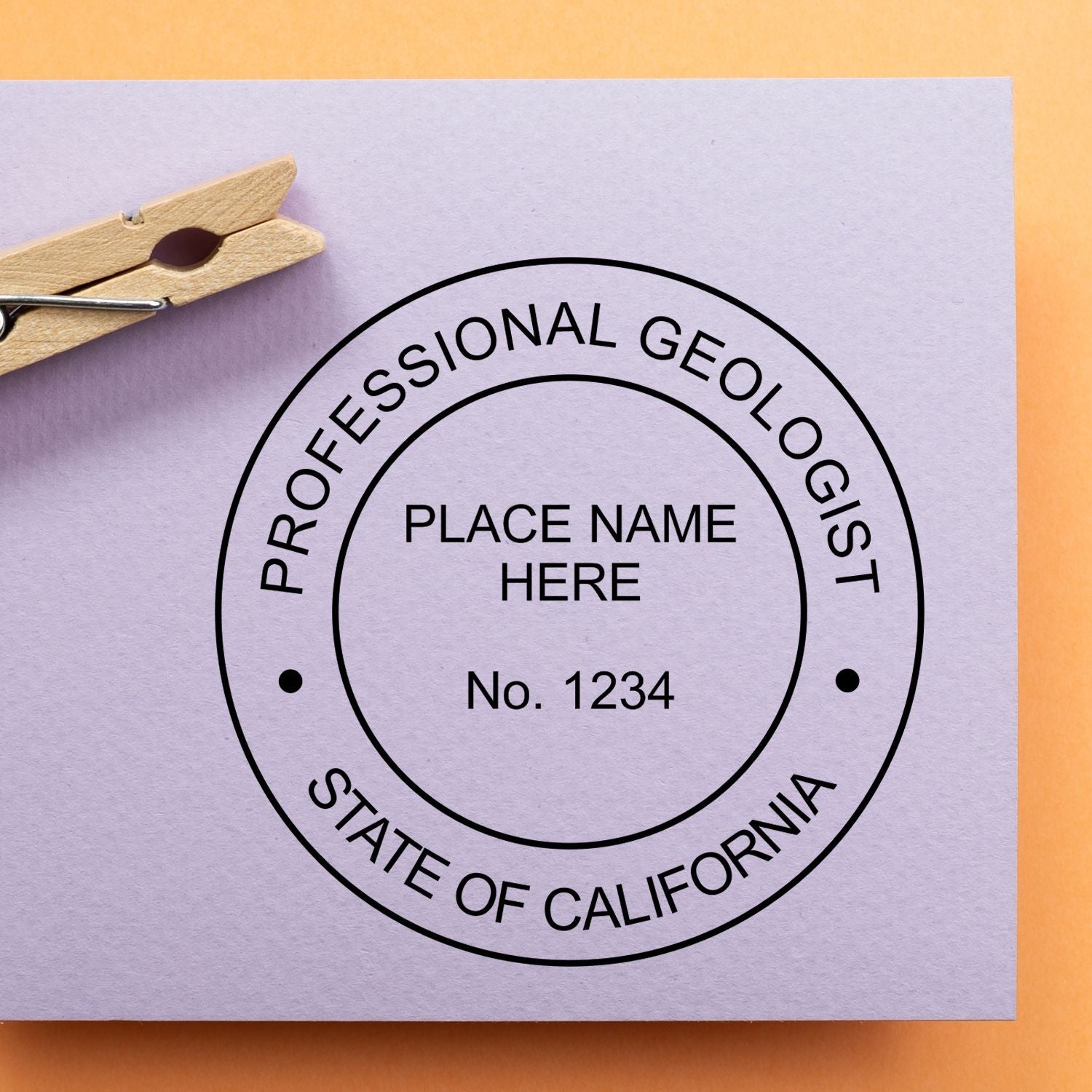 Image of a California Professional Geologist stamp on a purple card with a clothespin. Blog post: Cracking the Code: Understanding Geologist Stamp Regulations.