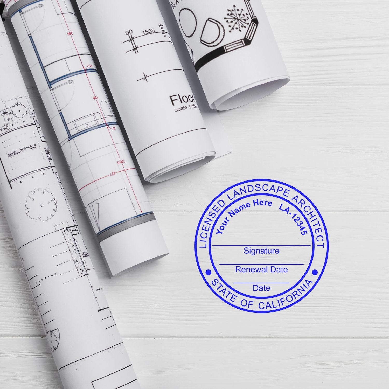 Rolled architectural plans and a blue California landscape architect seal stamp on a white wooden surface. Blog post: California Landscape Architect Feature Image.