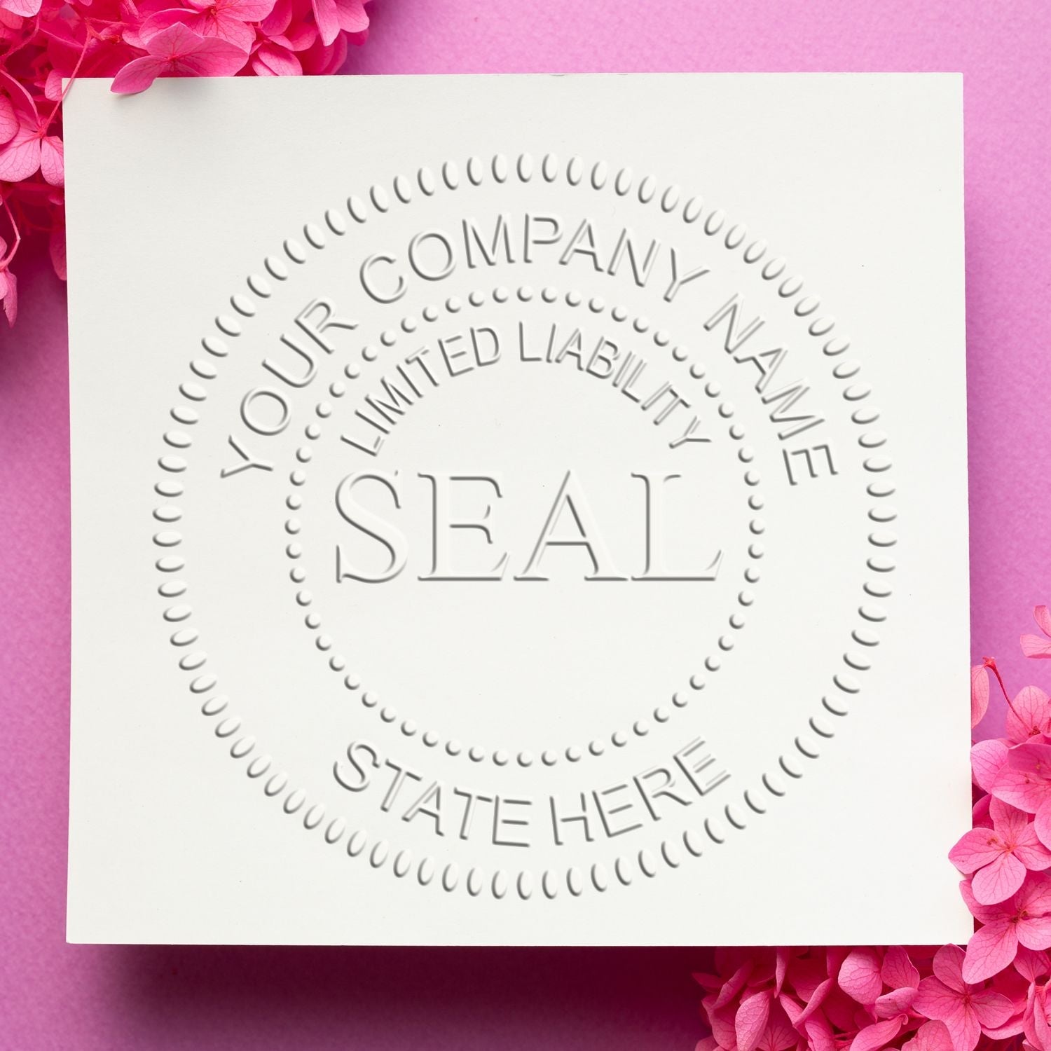 Embossed corporate seal on white paper with pink background and flowers. Blog post: Embodying Legitimacy: The Significance of Corporate Seals Feature Image.