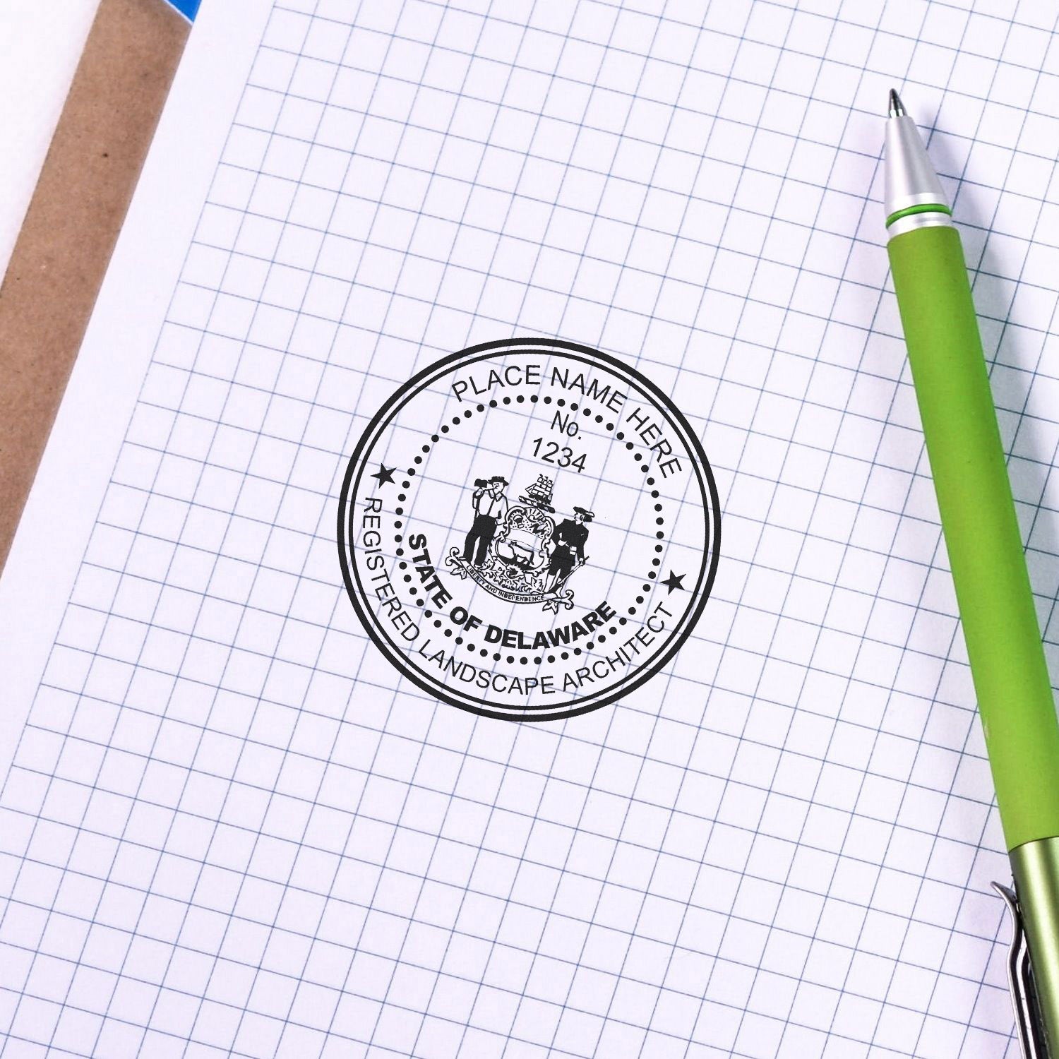 Delaware Landscape Architect Feature Image: A green pen next to a Delaware landscape architect seal stamp on graph paper.