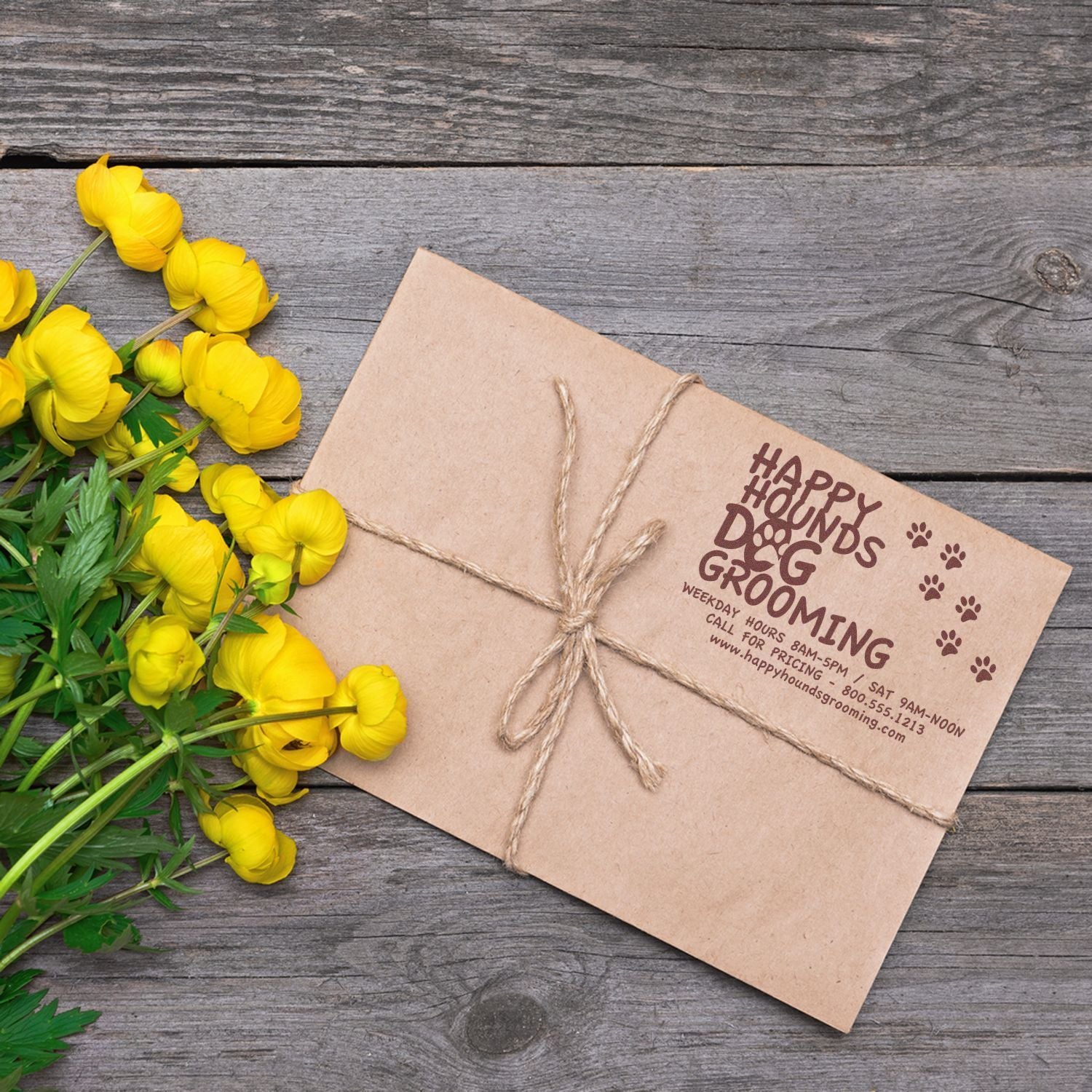 Return Address Stamps for Business Blog Post Feature Image: A kraft envelope stamped with a dog grooming business return address, tied with twine, next to yellow flowers.