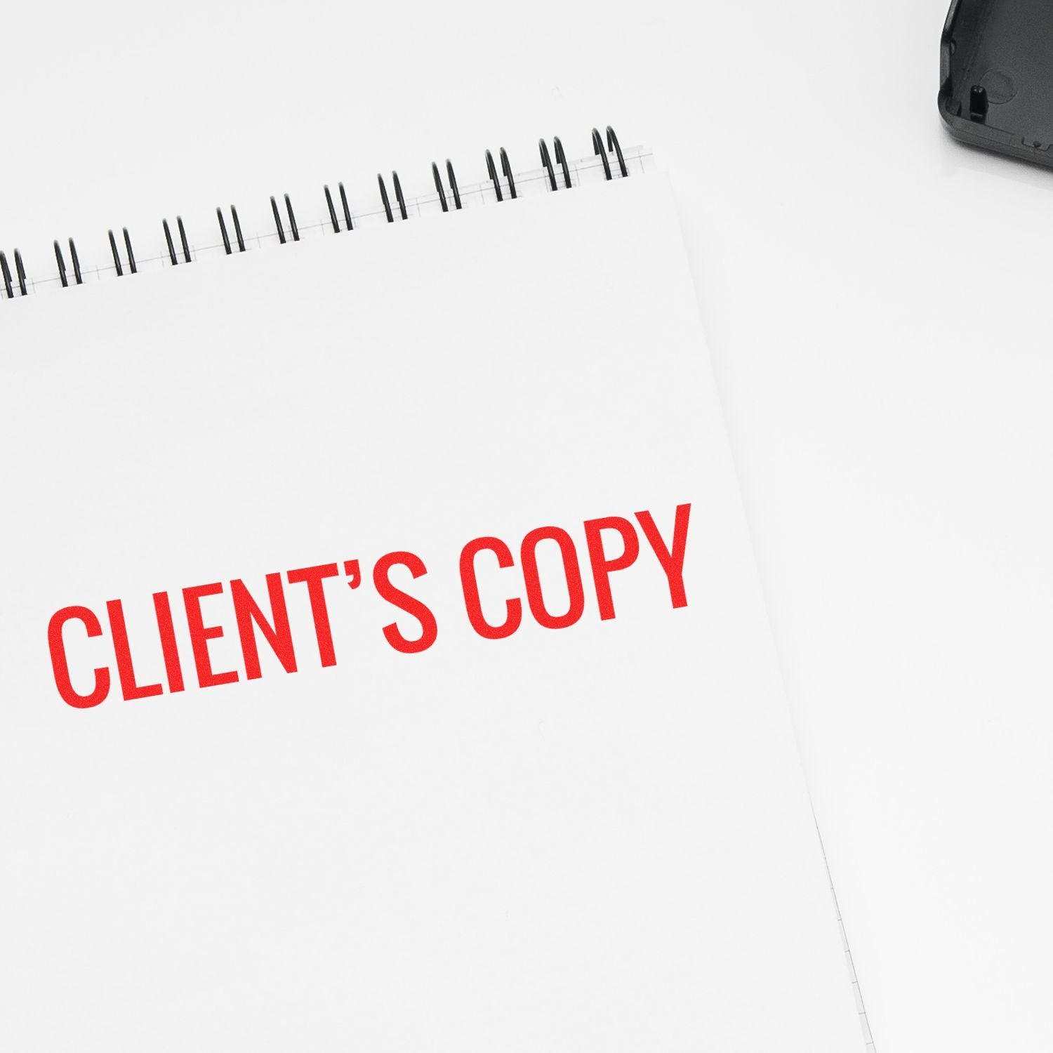 A notepad stamped with CLIENT'S COPY in red ink, featured in the Rubber Stamps for Attorneys Blog Post Feature Image.