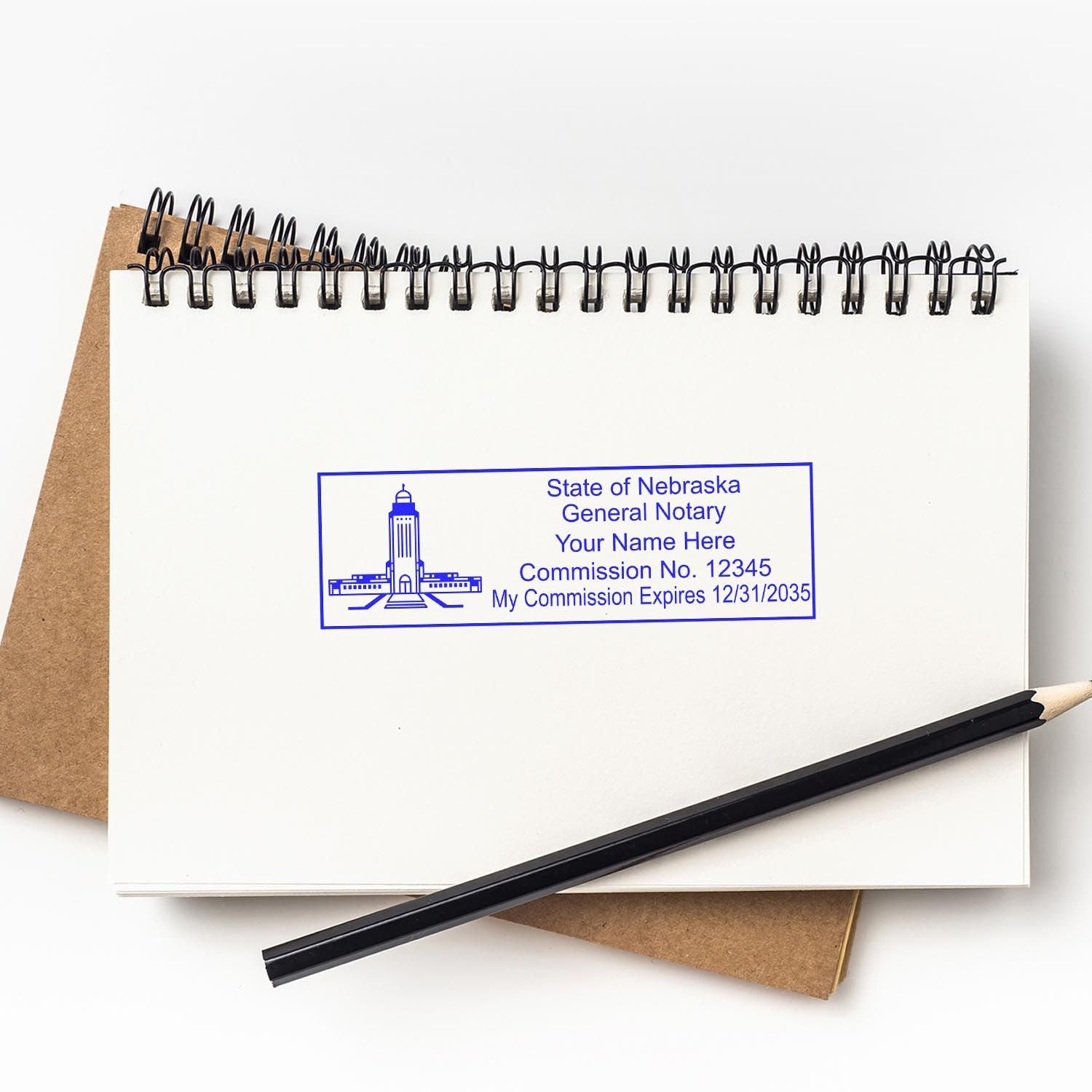 Nebraska Notary Supplies, Notary Public Seal Embossers and Notary Stamps blog post. Rectangular notary stamp on a notebook with a pencil.